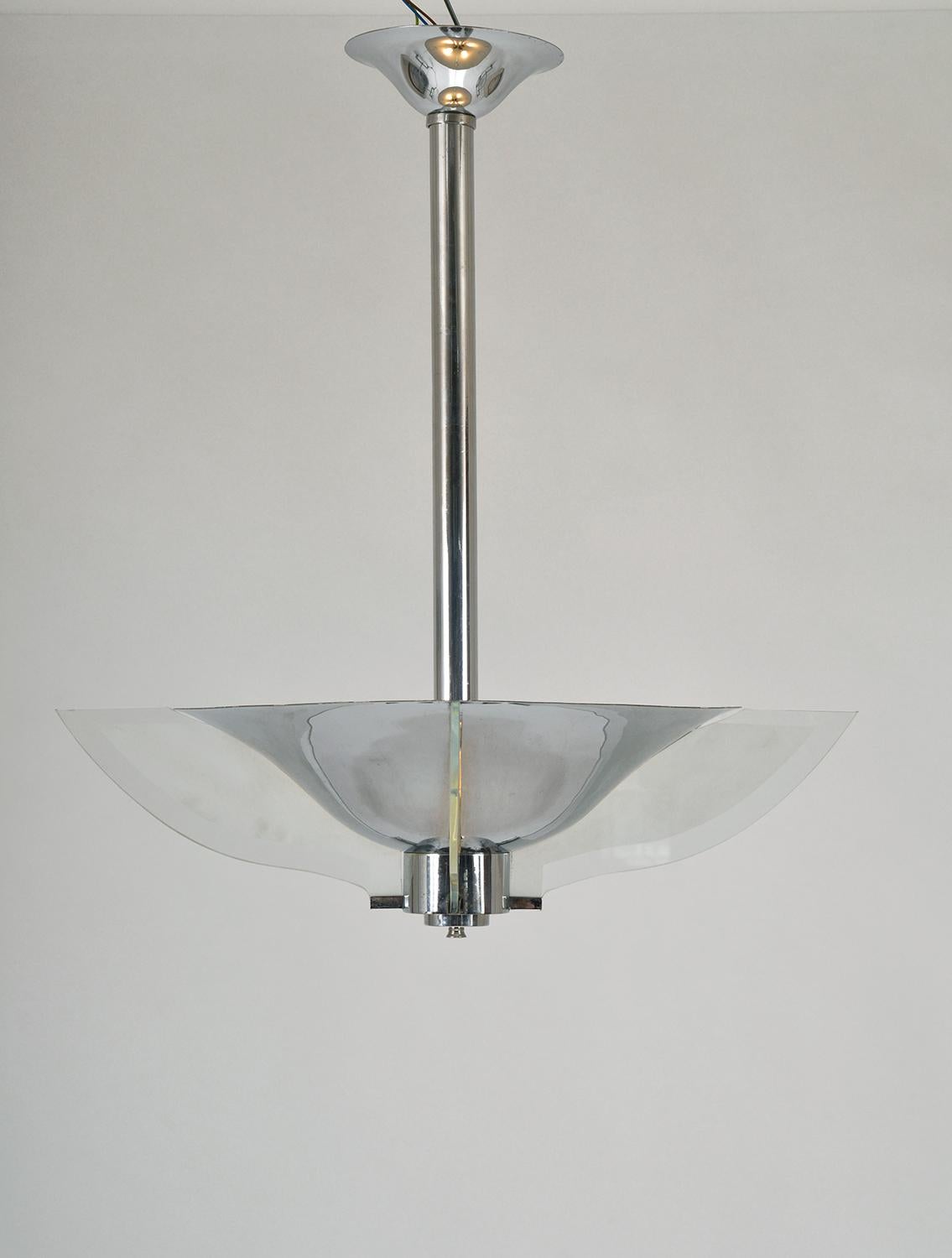 This chrome and glass ceiling pendant light is a stunning example of French Art Deco by Petito. Hanging from a chrome ceiling rose and rod, the chrome shade is fitted with thick frosted glass ‘petals’, which slot into the shade. The thick chrome is