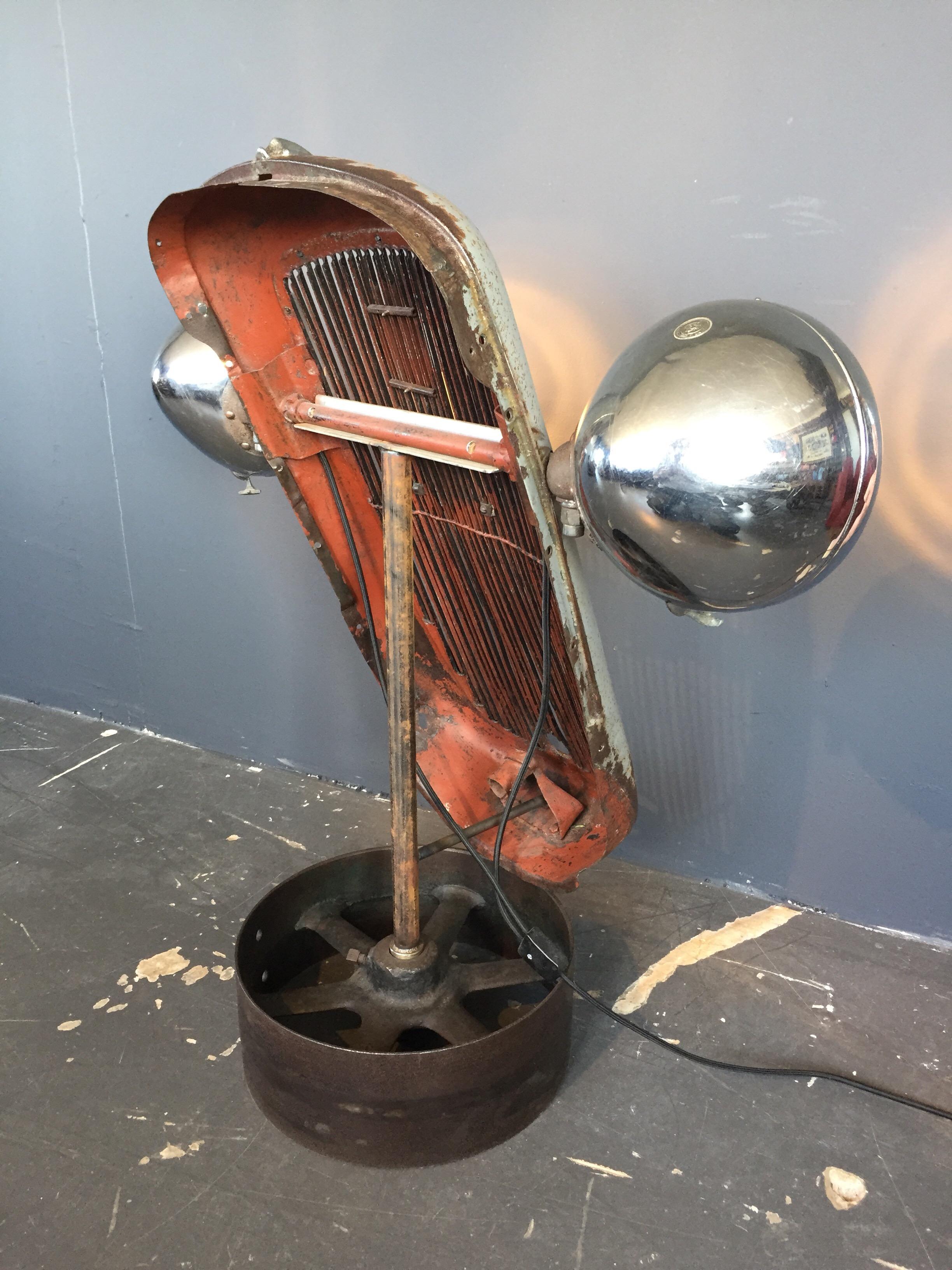 1930s Austin 10 Grille with Lucas King of the road head lights.
Mounted onto a cast iron base and converted with LED lights.
Original paint and with an overall great patina to the paint, brass and iron.
Can be fitted with an EU UK or US electrical