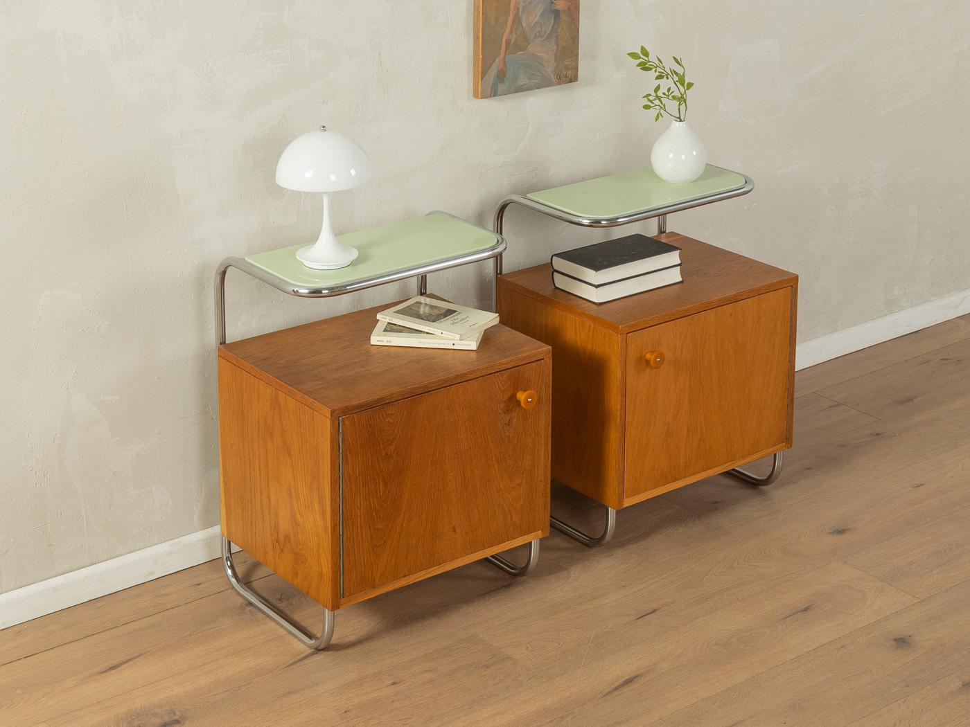 Wonderful bedside tables by Kovona from the 1930s. Corpus in ash veneer with one door, one shelf in mint green and chromed metal frame. The offer includes two bedside tables.

Quality Features:
very good workmanship
high-quality materials
Made in