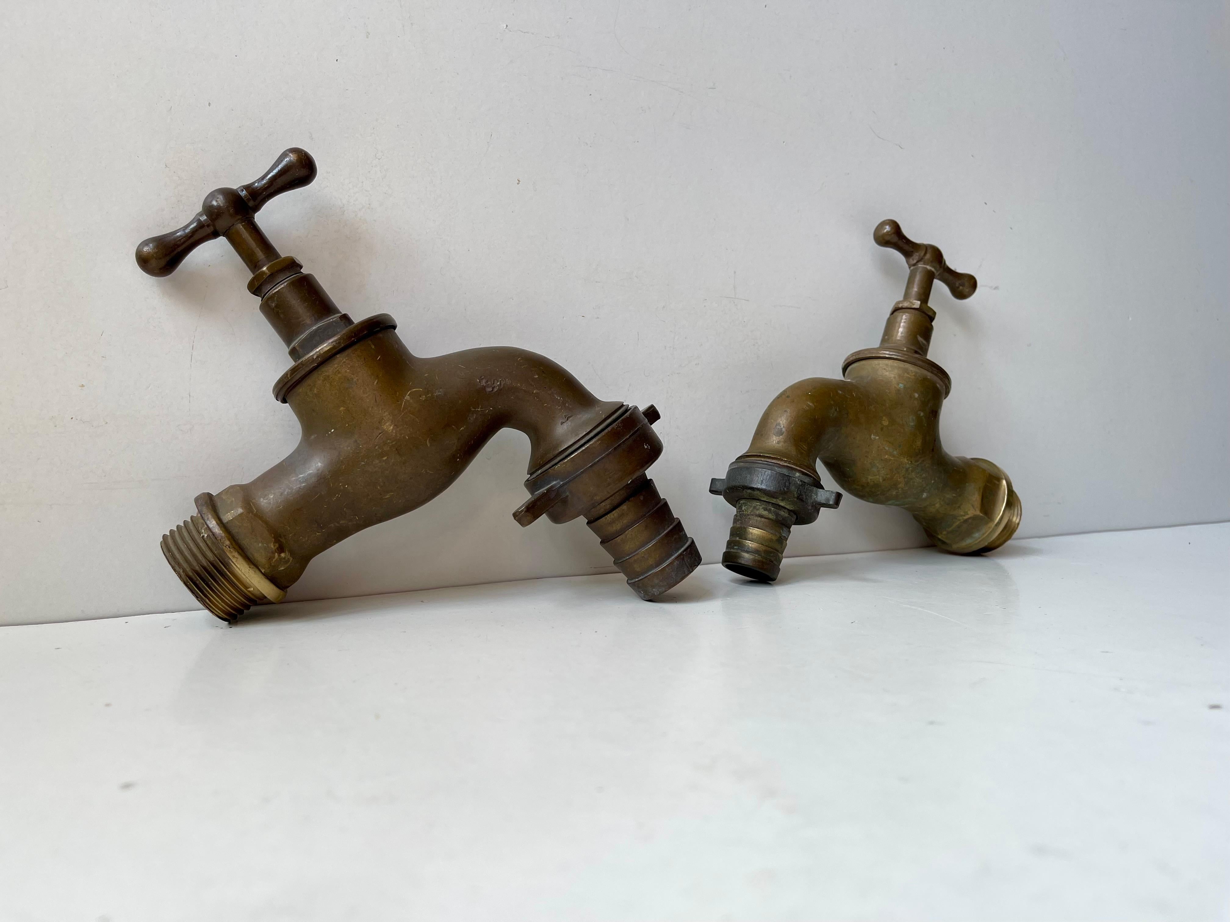 A set of 2 large solid brass water faucets. Both tested and in working order and both come with original hose connectors. Made in Europe, probably Scandinavian/Sweden during the 1930s. Your 1930s Bauhaus, Art Deco or Funkis House or garden deserves