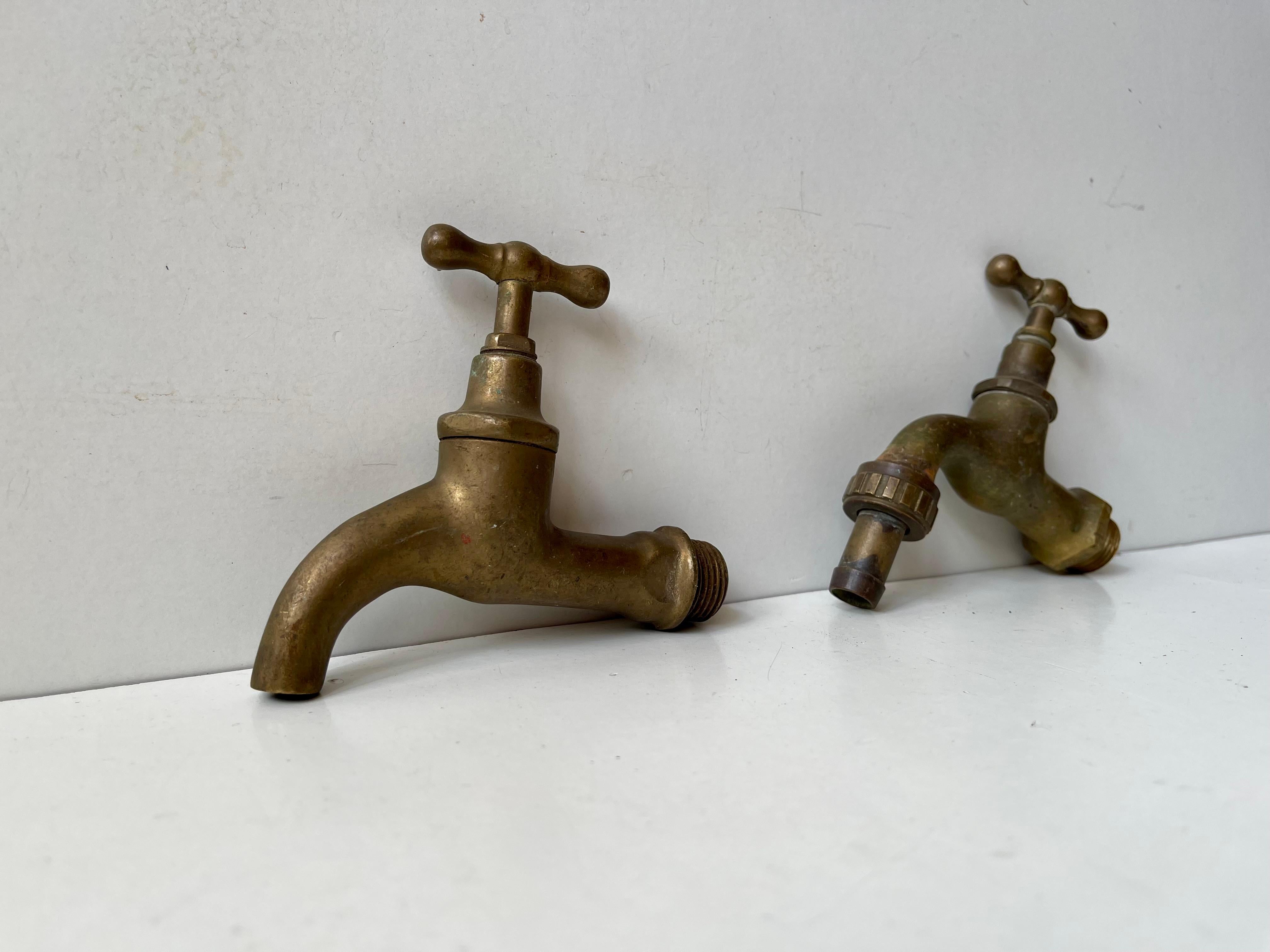 A set of 2 solid brass water faucets. Both tested and in working order. Made in Europe, probably Scandinavian/Sweden during the 1930s. Your 1930s Bauhaus, Art Deco or Funkis House deserves period taps. These come weathered and with undisturbed