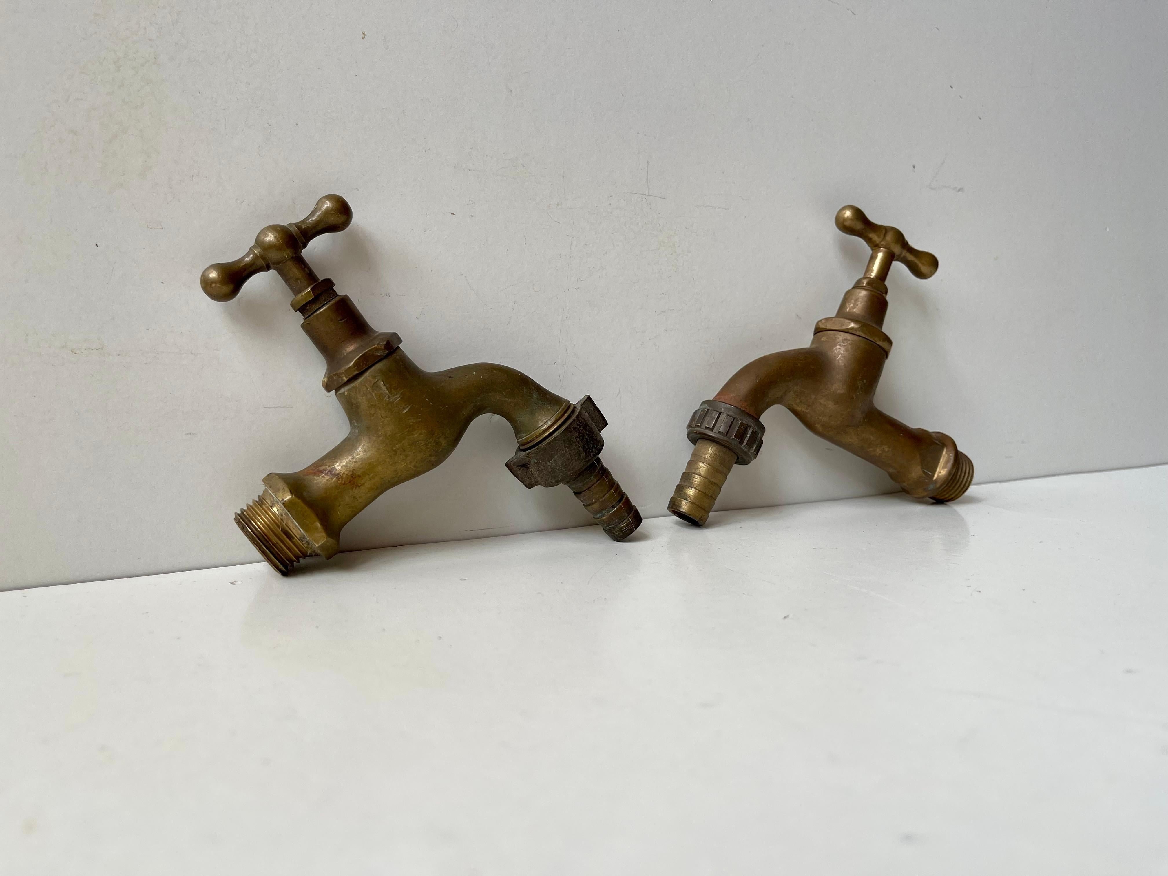 A set of 2 solid brass water faucets. Both tested and in working order and both come with original hose connectors. Made in Europe, probably Scandinavian/Sweden during the 1930s. Your 1930s Bauhaus, Art Deco or Funkis House deserves period taps.