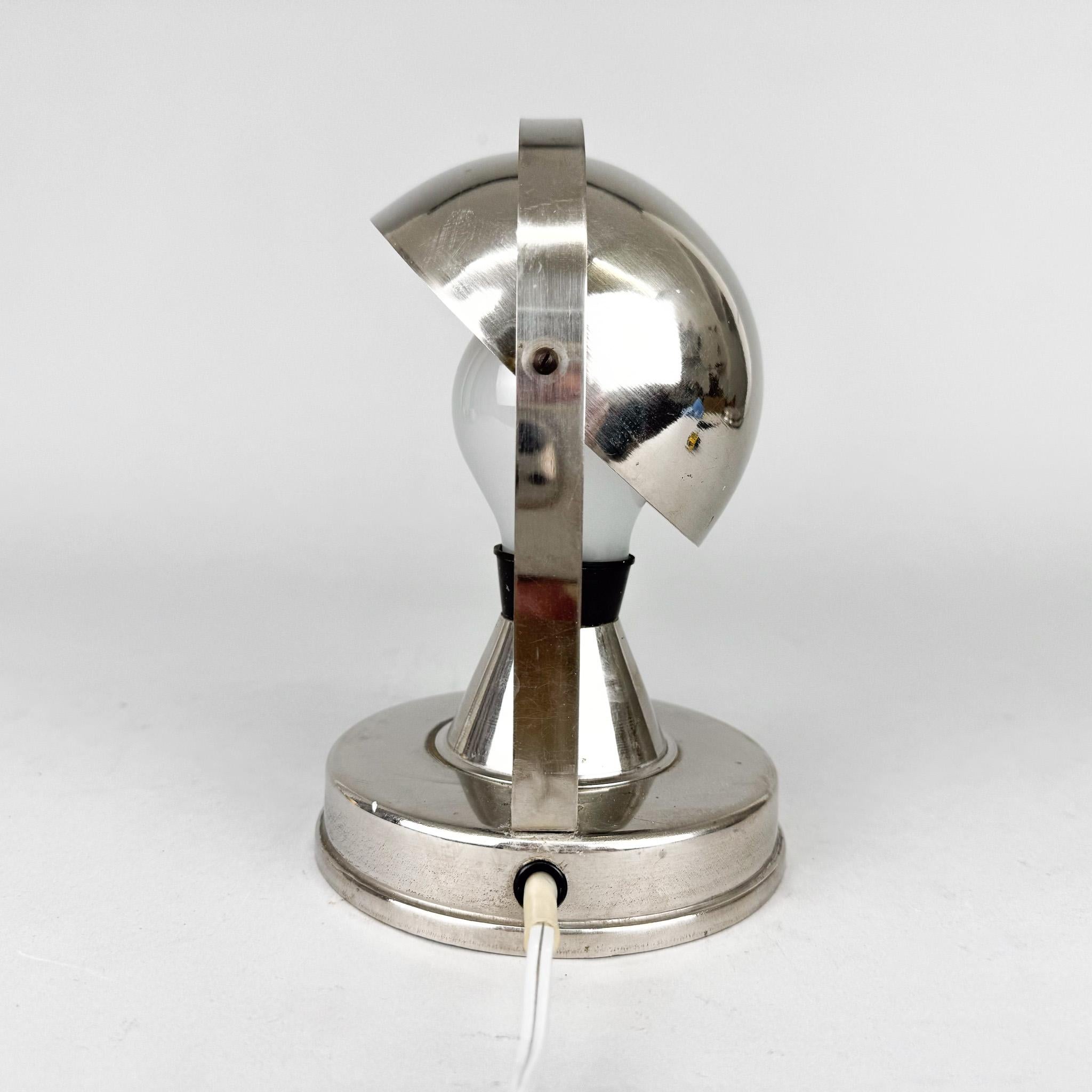 Pequeña lámpara de mesa cromada de la época art déco con pantalla regulable, como puede verse en las fotografías.  Cableado original y totalmente funcional. Bombillas: 1 x E26 (E27). Adaptador para EE.UU. incluido.