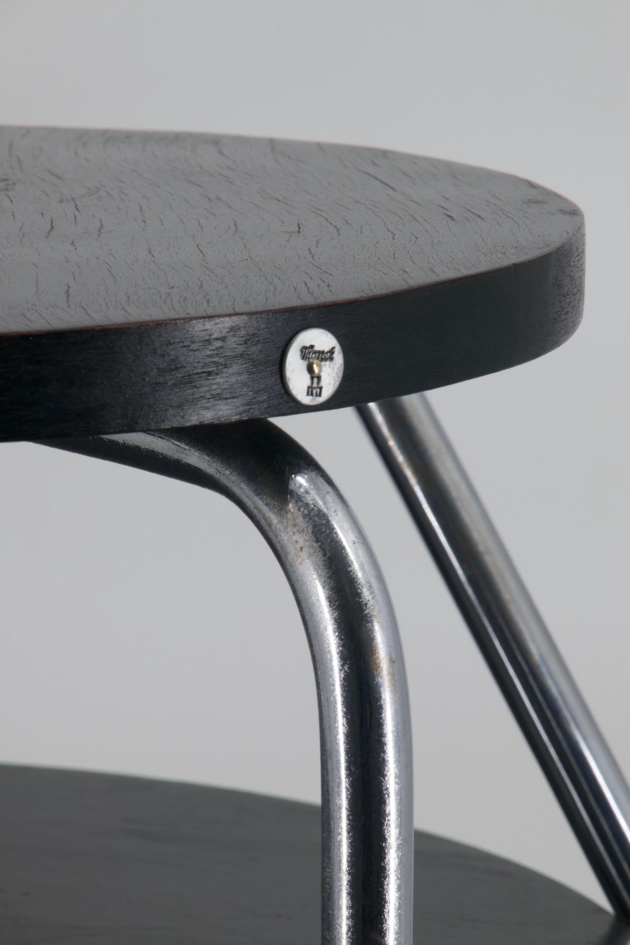 This Thonet 1930s modernist table is the rare model B153, identified in a 1930s Thonet catalogue, see picture. A unique and Avant Garde design with an asymmetric chromed steel tubular structure and two lacquered black wood all in its original
