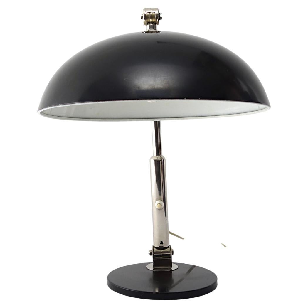 Stylish and practical desk lamp made of black steel and chrome. This 1930's model is ingeniously designed by Dutch designer H. Th. J. A. Busquet (1914 - 1977). It is adjustable at two hinge points. 

A majestic and efficient object for your bar,