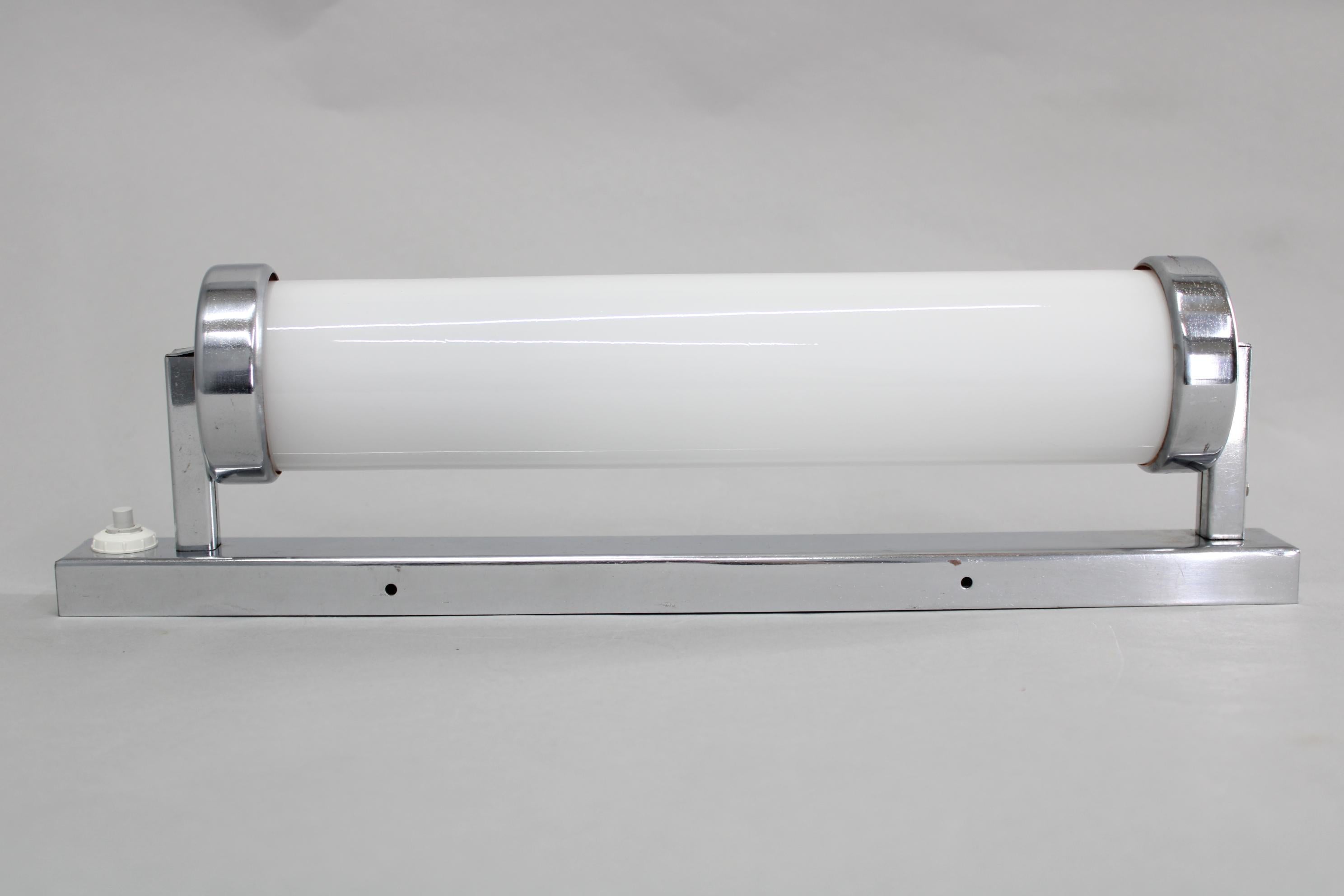 Classic Bauhaus tubular wall light, crafted in Czechoslovakia during the 1930s, with a chrome-plated metal frame and glass tube diffuser. Recently rewired, compatible with a single E14 or E12 bulb, and ready for US wiring (a plug or socket adapter