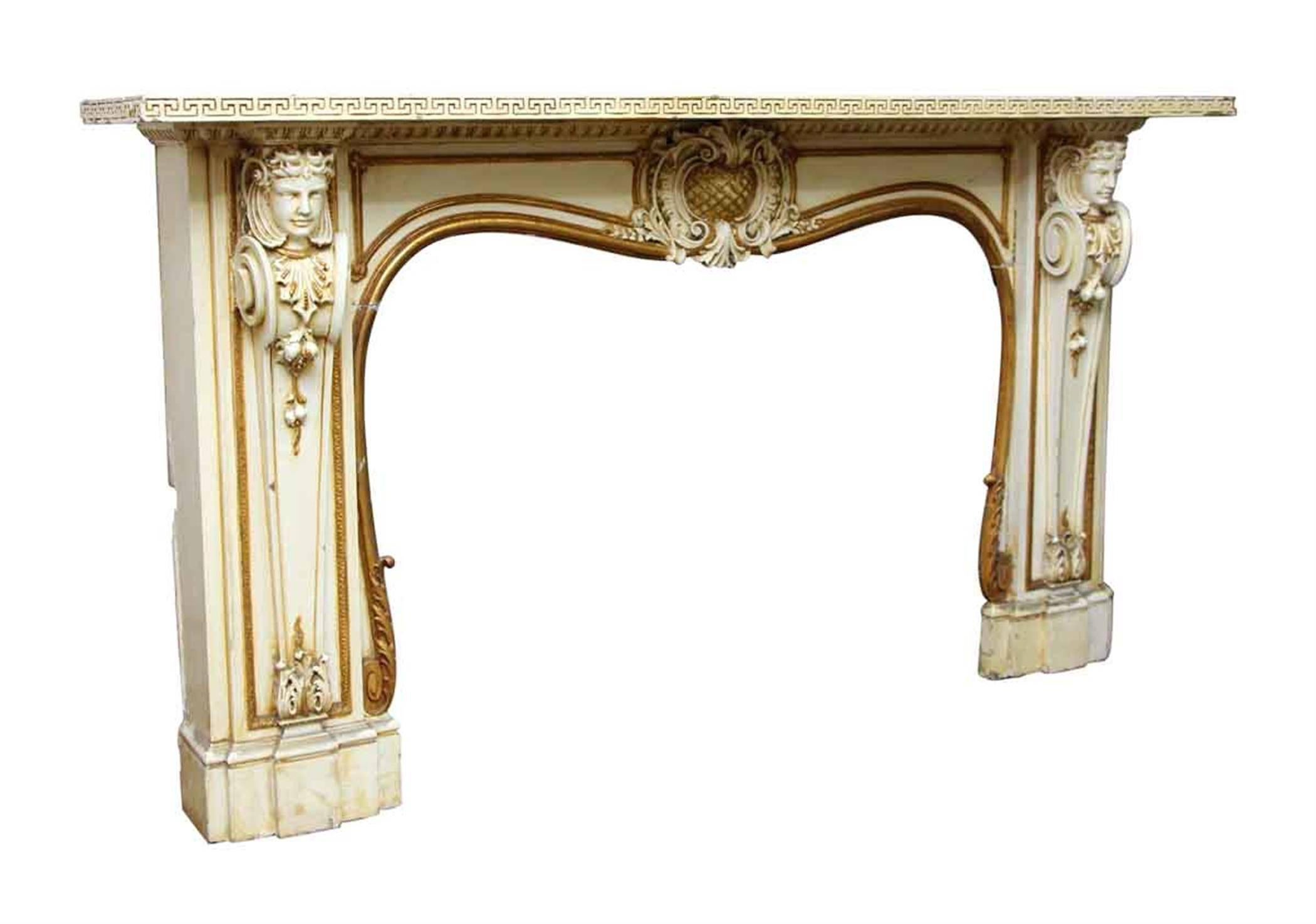 1930s cream and gold painted wooden mantel with two figures adorning each side. Rescued from a Park Ave apartment. This can be seen at our 400 Gilligan St location in Scranton, PA.
