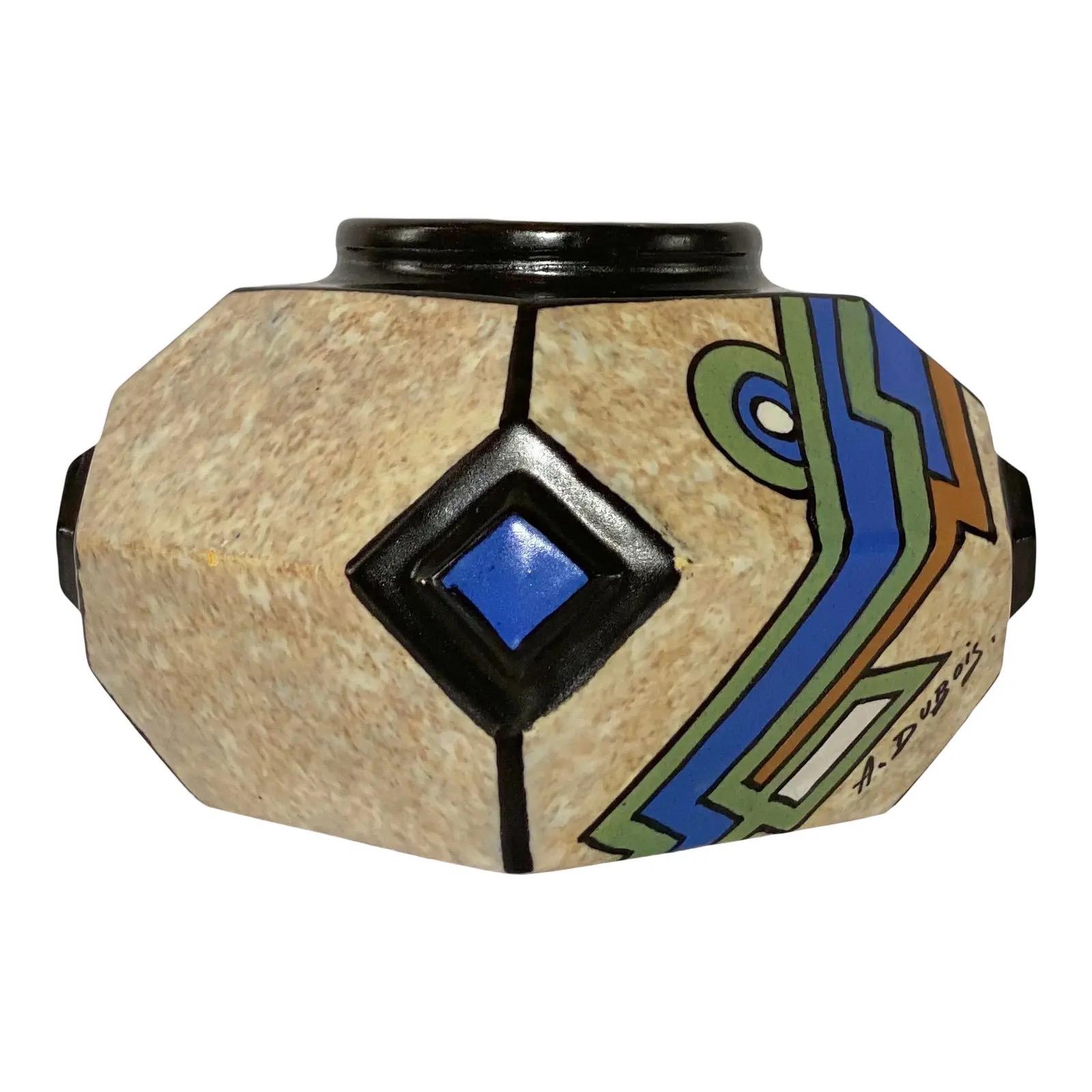We are very pleased to offer a hand painted, cubist vase signed by the Belgian artist A. Dubois, circa the 1930s. The polychrome vase showcases blue, green, and brown geometric panels on a speckled tan and white background. In great vintage