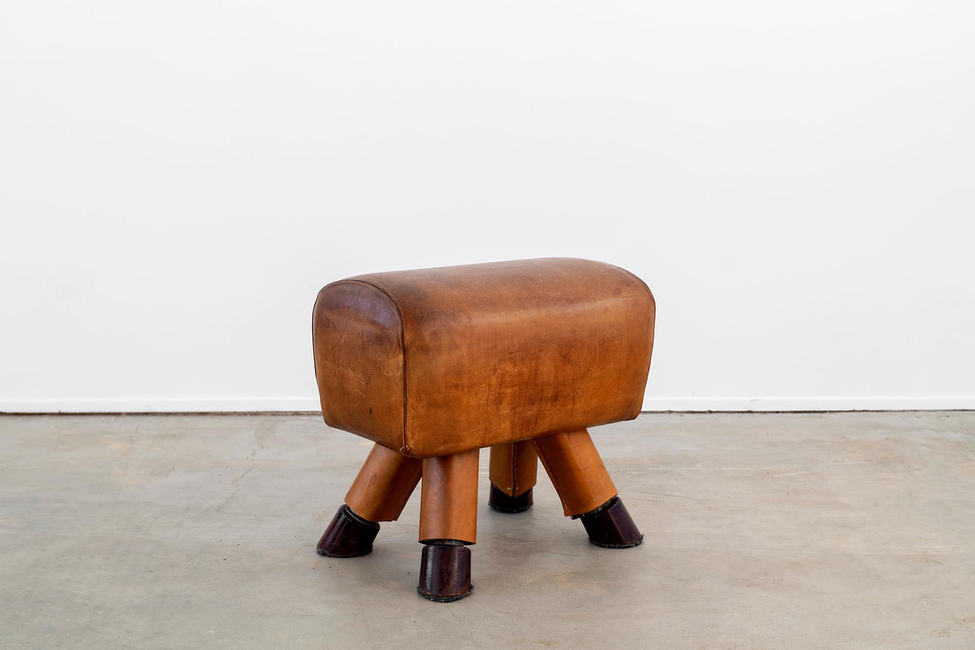 Collection of Belgian leather gym benches circa 1930s with fantastic patina in various shapes and styles.
Angled legs with original thick iron feet.
Priced individually.  

    