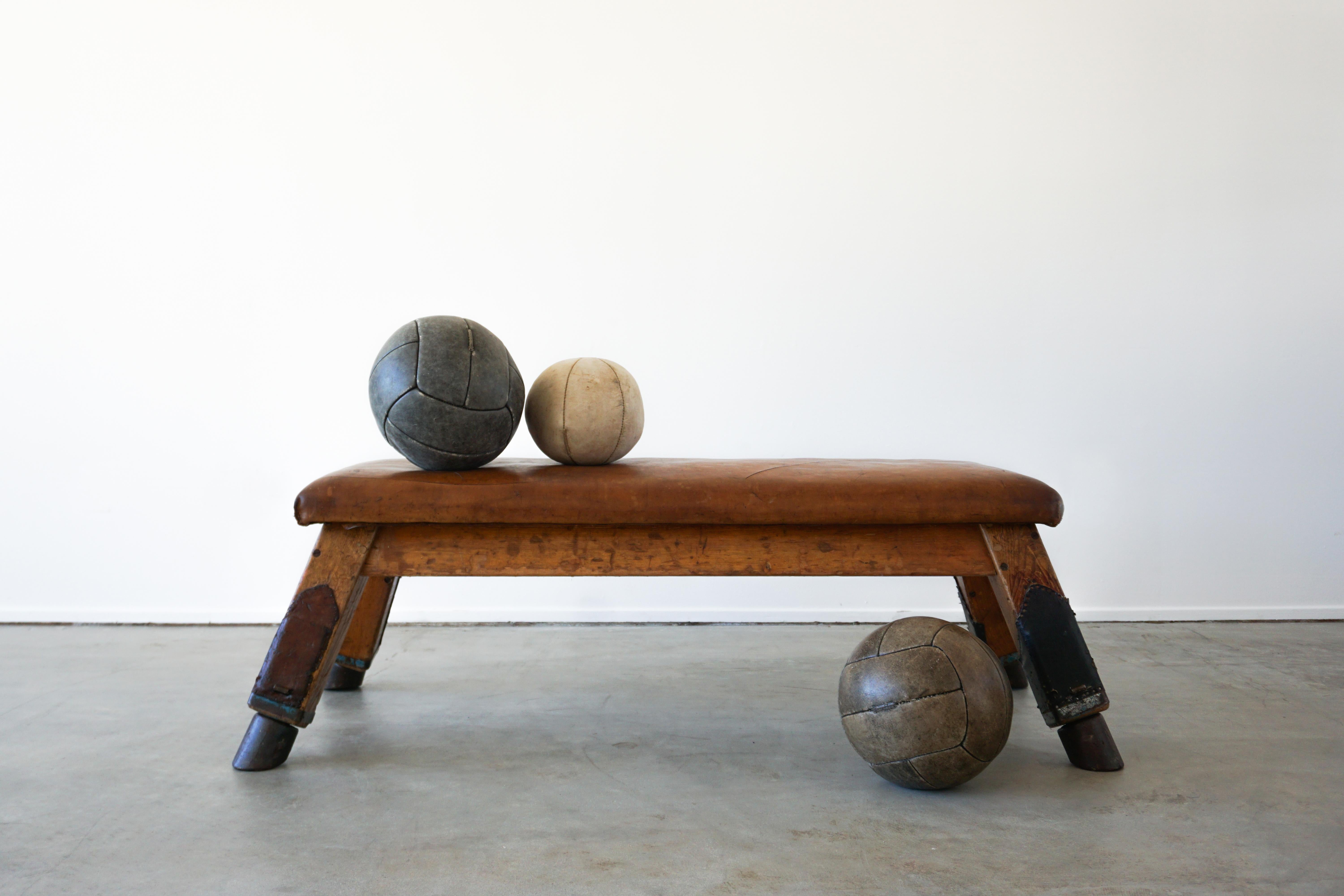 Wonderful Belgian leather gym bench circa 1930s with fantastic patina and lines.
Thick iron feet and oak legs. 
   
 