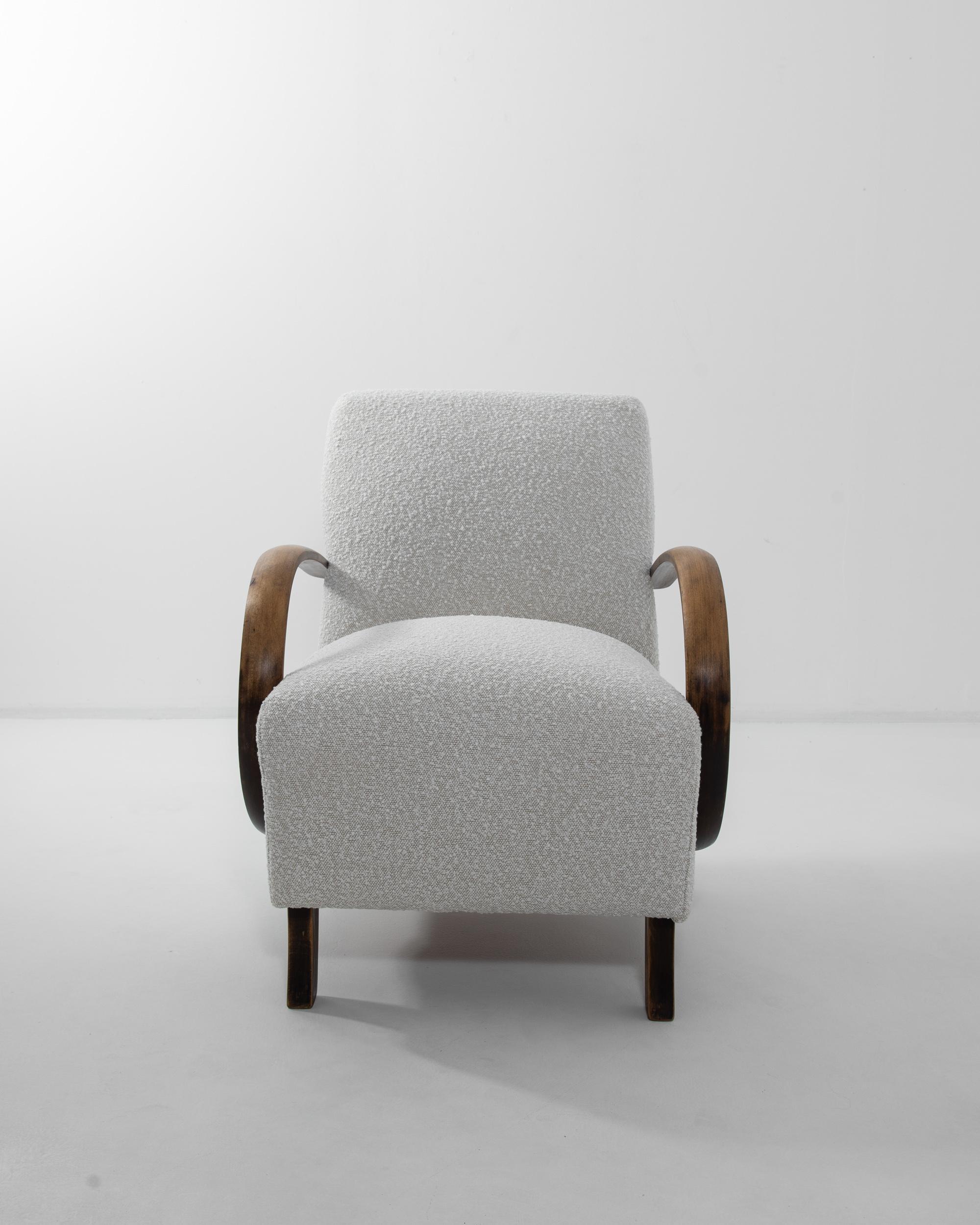 Classic bentwood combines with reupholstered white bouclé in this iconic design by J. Halabala. The chair’s curving legs and bentwood armrests dream up the dynamism of the piece. Contemporary fabric was chosen to enhance the sumptuous shape of the