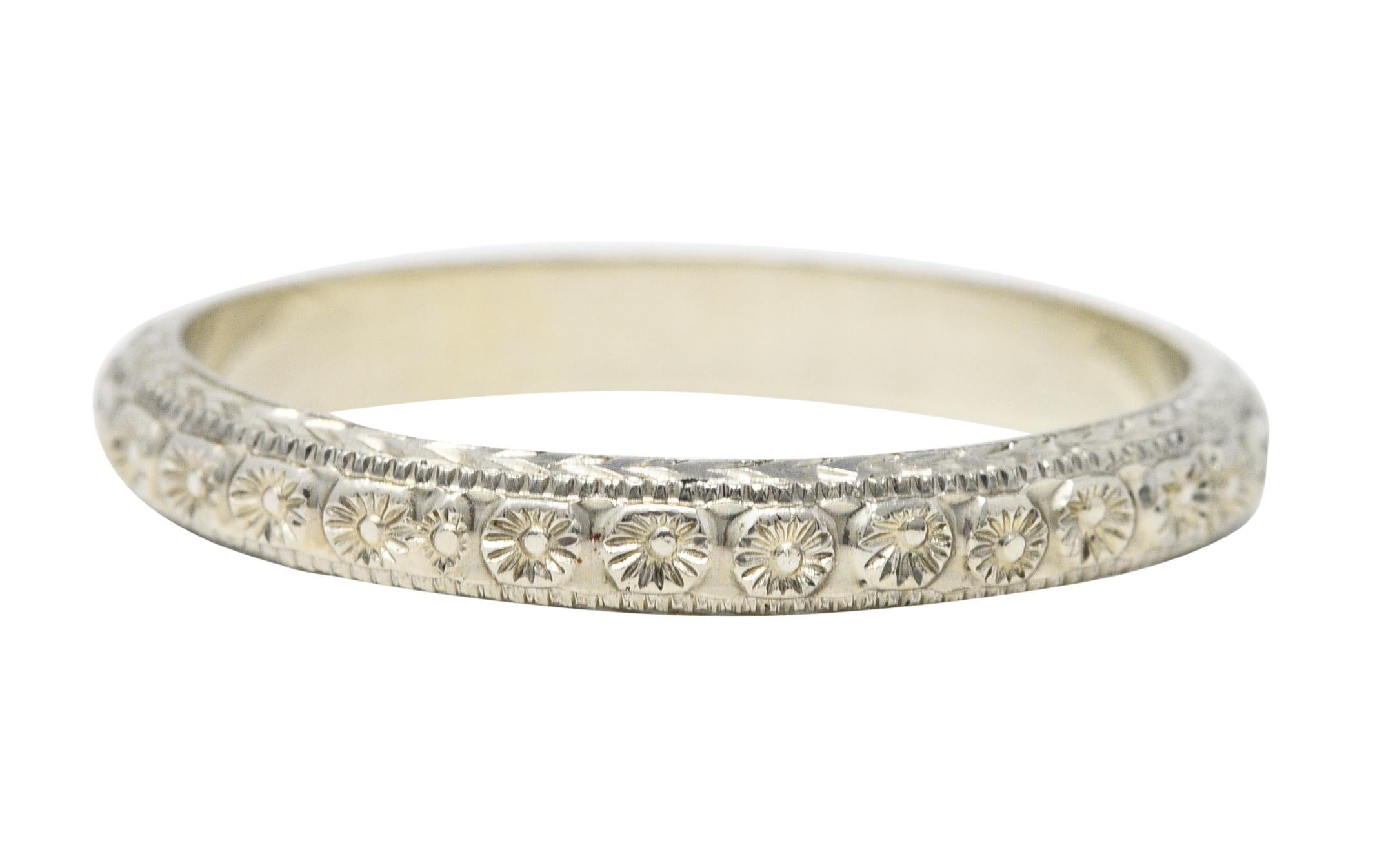 Band ring is highly rendered with an orange blossom motif fully around

With a wheat motif engraved profile

Stamped 18K for 18 karat gold

Maker's mark for The Bernstein Jewelry Co.

Circa: 1930s

Ring Size: 9 & not sizable

Measures North to South