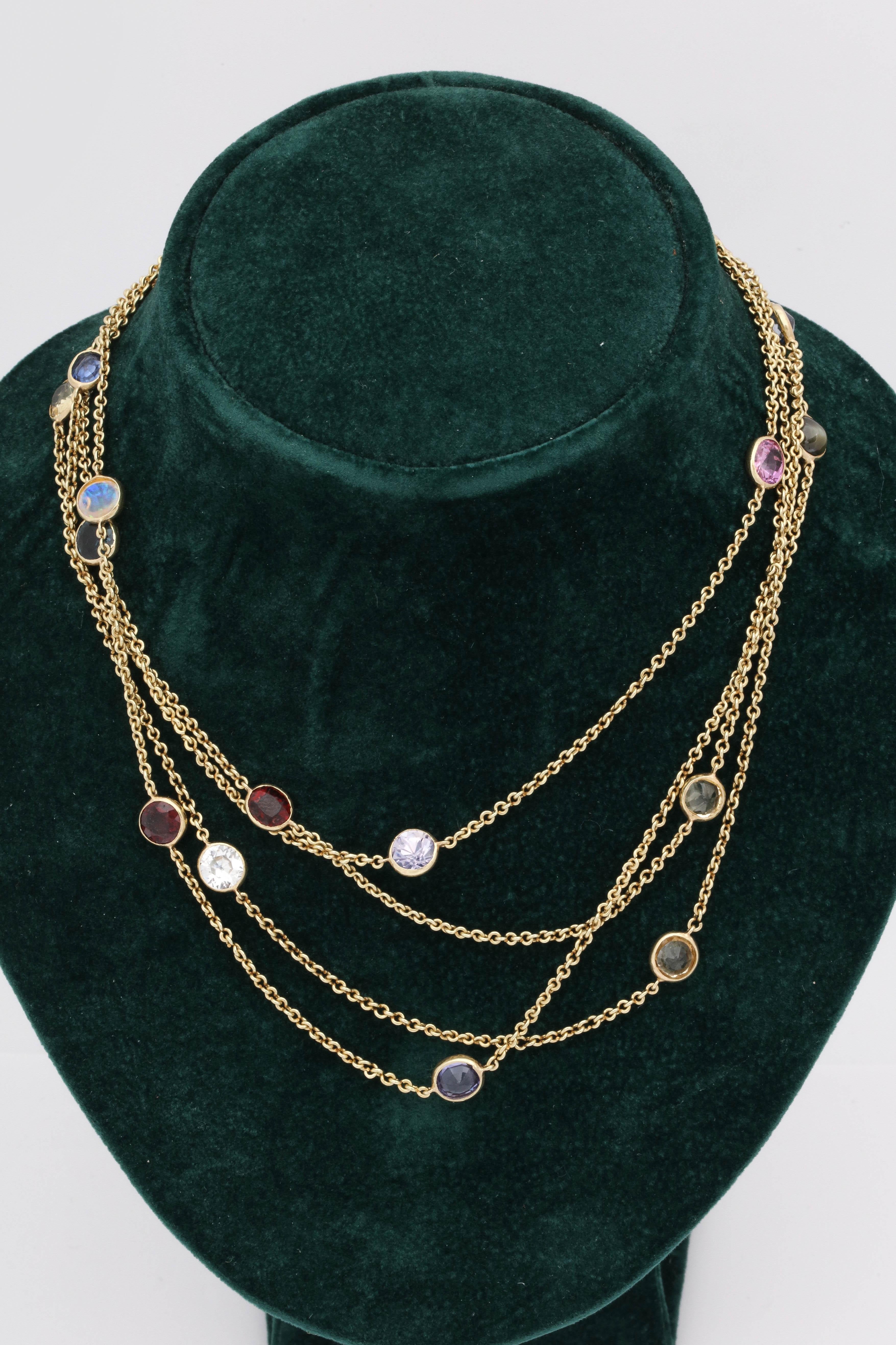 One Ladies 18kt Gold Long Link Chain Necklace Embellished With Nineteen Bezel Set Stones Composed Of Pink,Blue And Yellow Sapphires. Also Created With Rubies,Opals And Green Tourmaline And Pink Kunzite Stones Thruout.Made In The United States Of