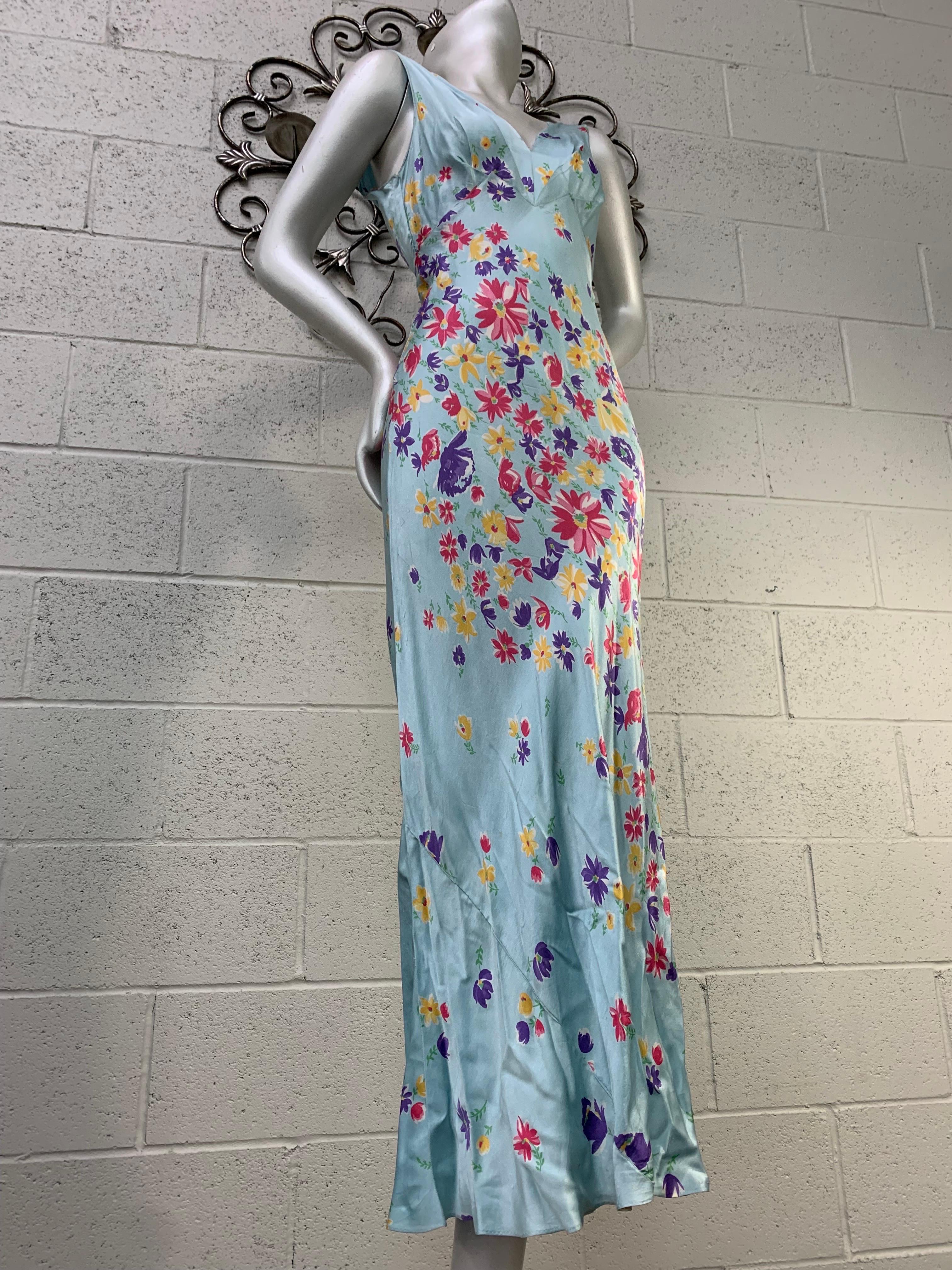 A lovely 1930s slip or negligee of bias-cut silk charmeuse in a classic silhouette: pale blue column wrapped with a multicolor floral descending spiral print. No closure. Size 4-6. A rare beauty. 