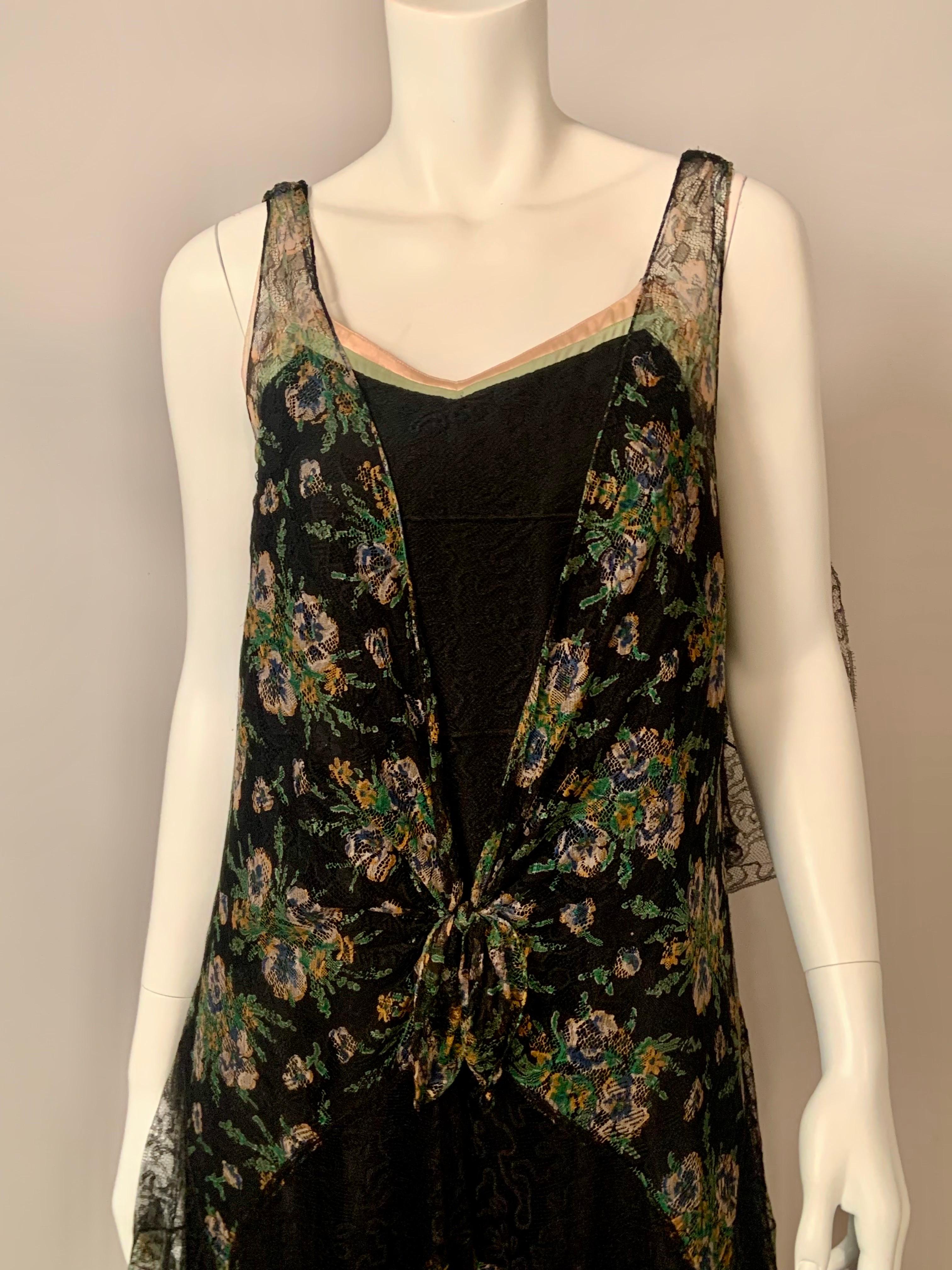 This dress is a gorgeous combination of black lace and pastel lace flowers incorporated into the design of more black lace. The hip length bodice is made from the pastel floral lace with a deep V shaped center front which has bands of pink and green