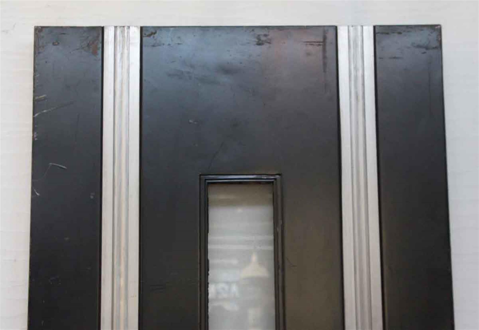 Art Deco black metal door with deco silver details and one thin glass strip in the center. From the 1930s Hayden Planetarium. This can be seen at our 1800 South Grand Ave location in Downtown LA.