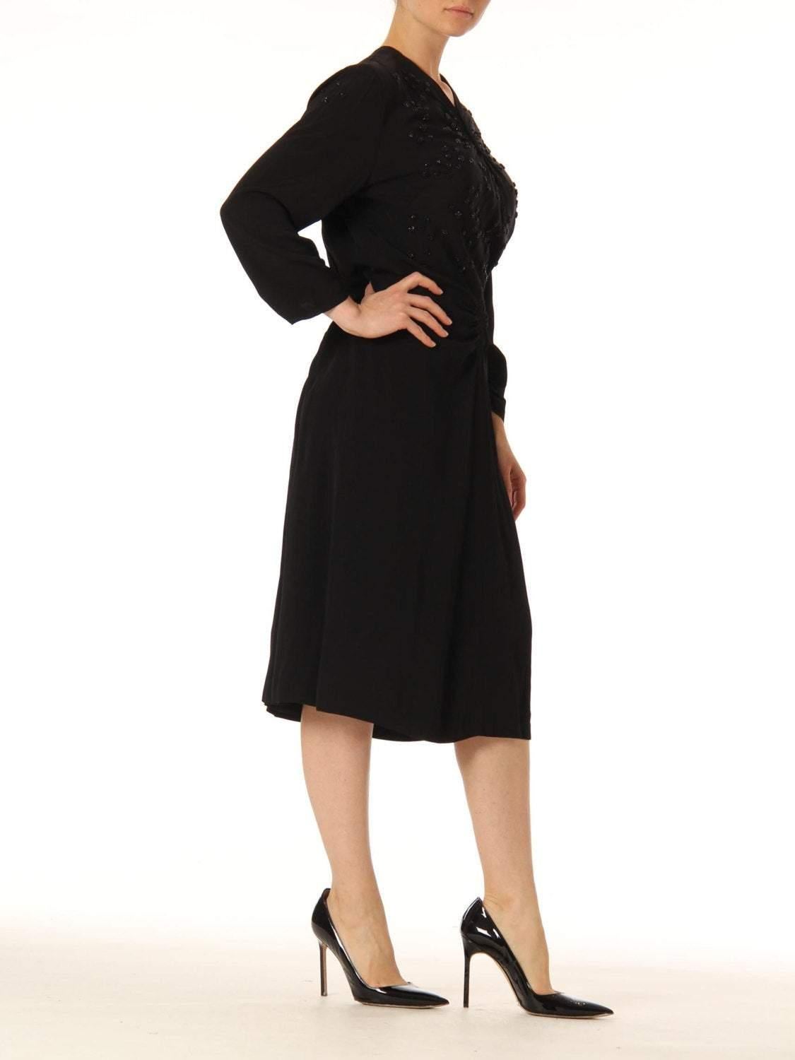 This dress has a sexy film noir fit and is cut for a larger and curvier woman than our model here who is a size 4. 1940S Black Silk Faille Long Sleeve Polka Dot Beaded Cocktail Dress Gathered On The Hips 