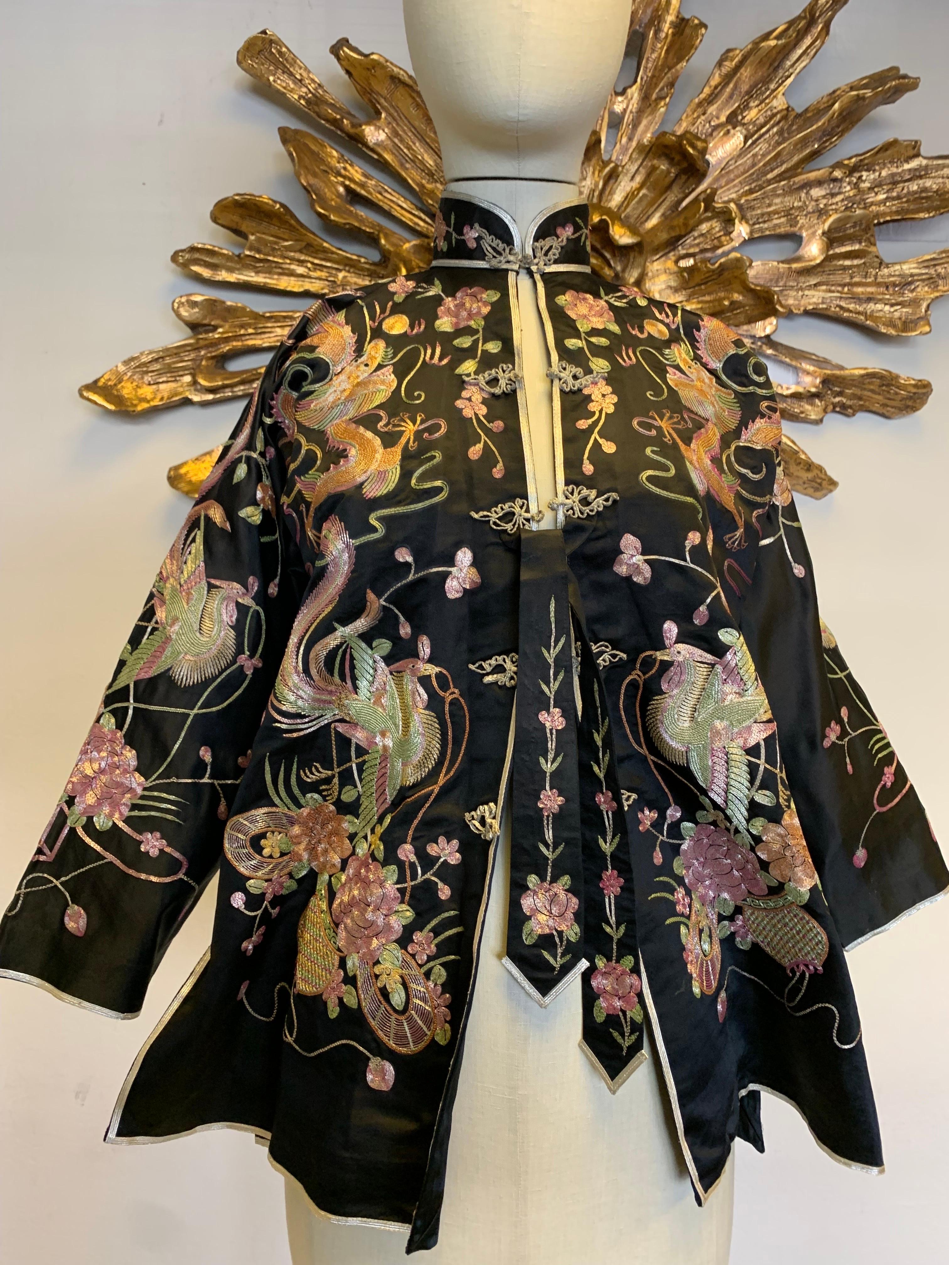 1930s Black Chinese Silk Jacket w Metallic Foil Embroidered Phoenix Birds: An extraordinarily pristine example of traditional embroidery on this fashionable flared peplum silhouette. Mandarin collar with frog closure and front waist ties. US size