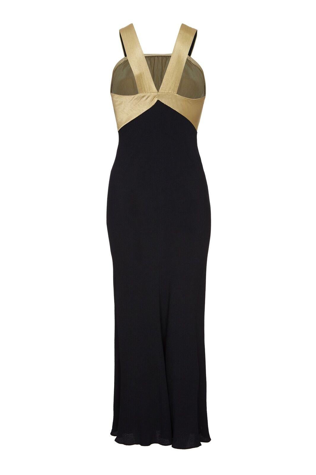 This sensational 1930s evening gown is fashioned from a soft black bias cut crepe fabric and falls snugly over the hips with a gentle outwards flare towards the ankle. The gold silk bodice is embossed with a delicate brush stroke design and draws