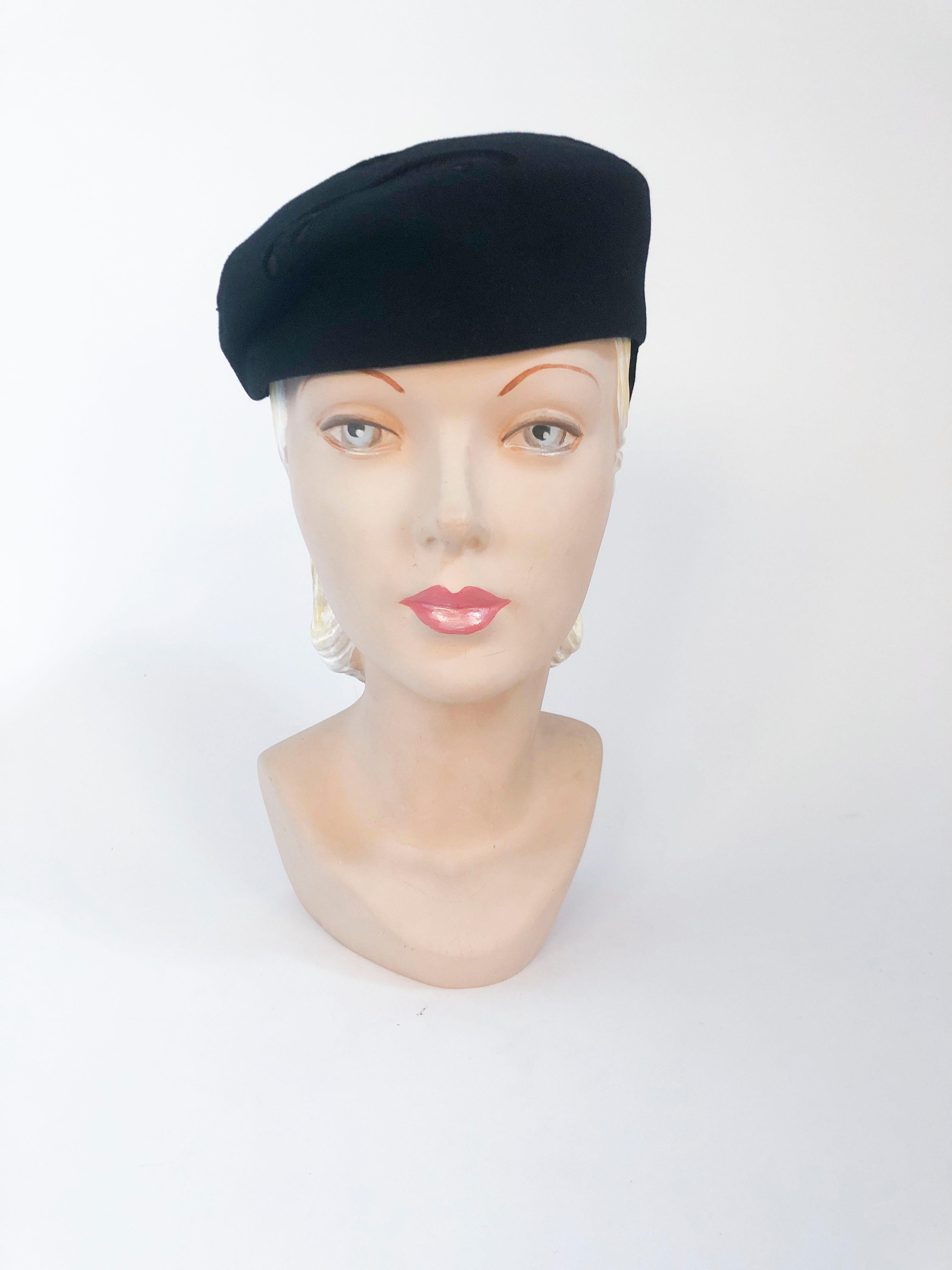 1930s Black Fur Felt Hat With Deco Cut Accent. This hat is structured  like a beret but hat the band in the back to slant it. It also has a small tied bow on the back.