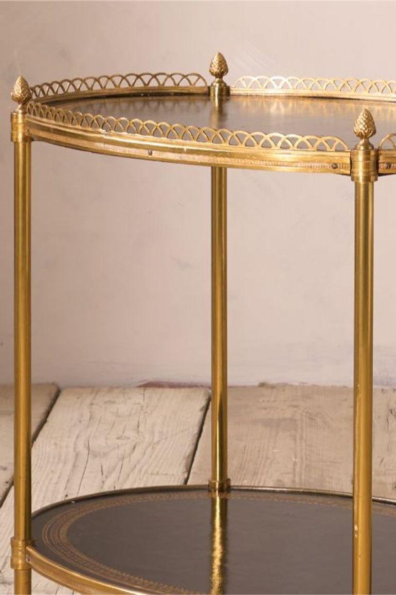 This is a very stylish 1930's drinks table in totally original condition. Sharp black leather with gilt tooled leather and brass fretwork boarder to the top tier. Complete with the original small brass casters.
The ideal drinking companion for