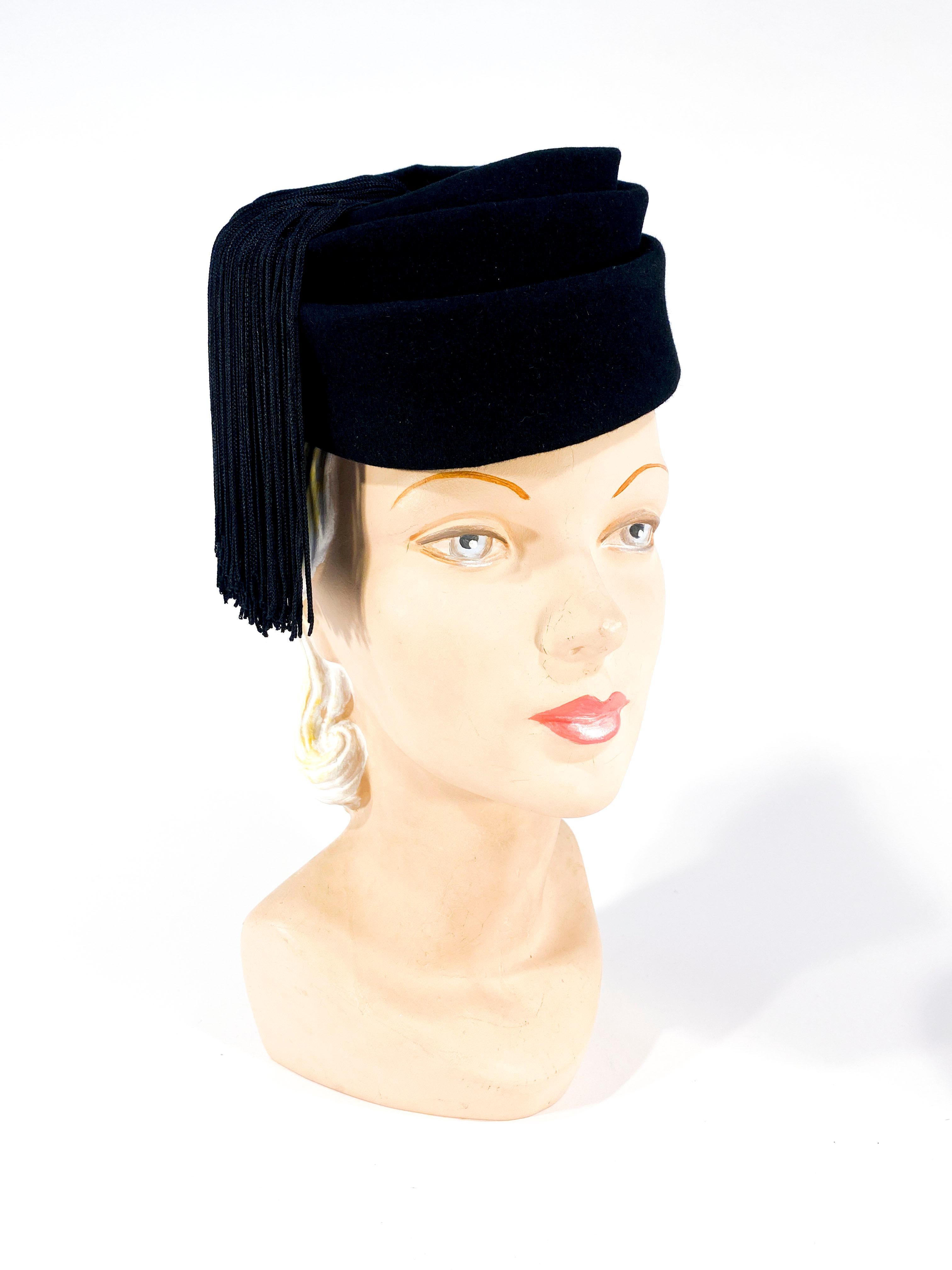 1930s custom made black beaver fur felt sculptured perch hat finished with two long silk tassels that hand down the side of the face. 