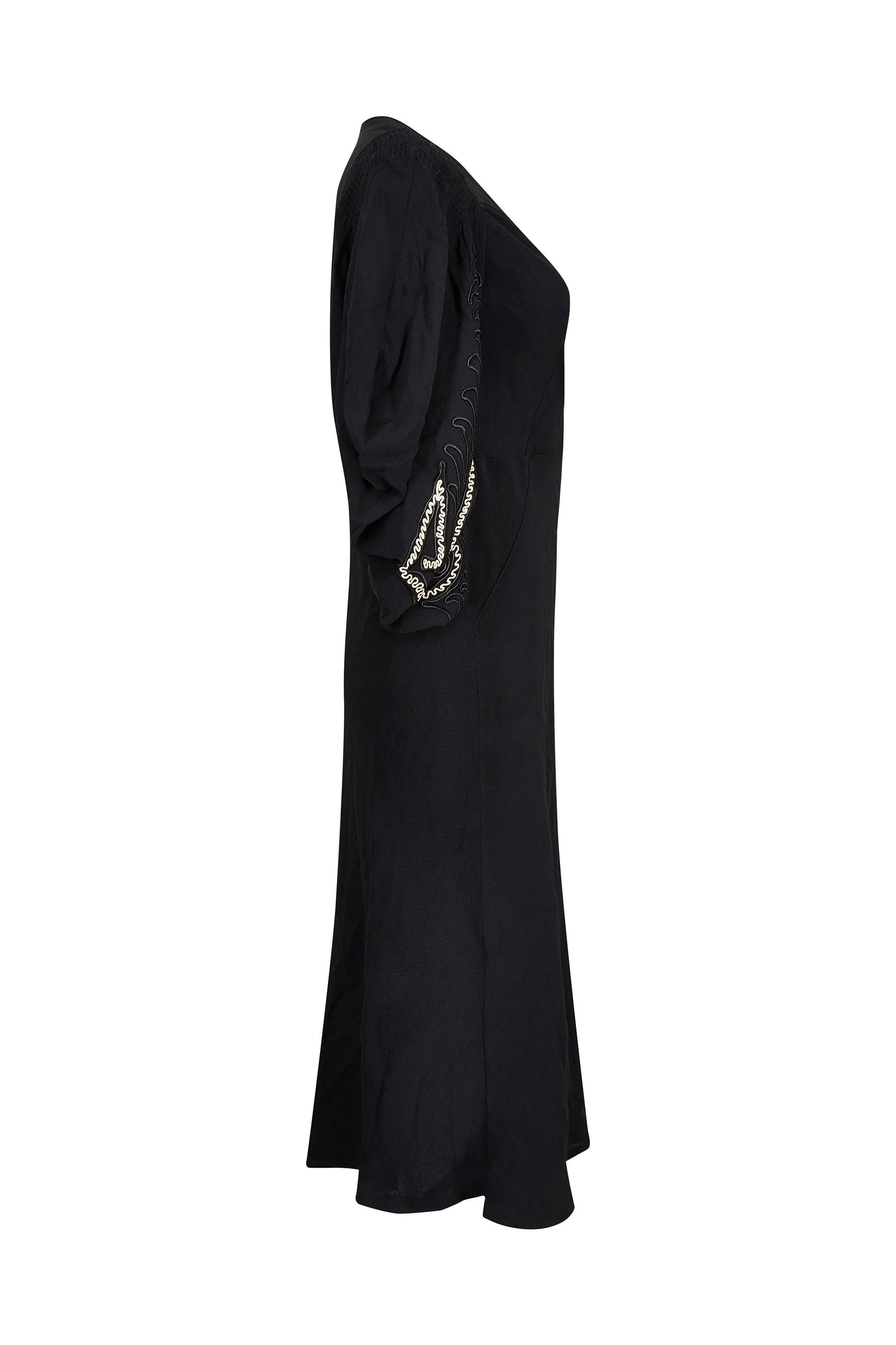 This striking 1930s black silk crepe gown with embroider kimono style sleeves is in superb vintage condition with some lovely design features. The dress is a designed to be a lose fit and is reminiscent of the flapper style however there are details