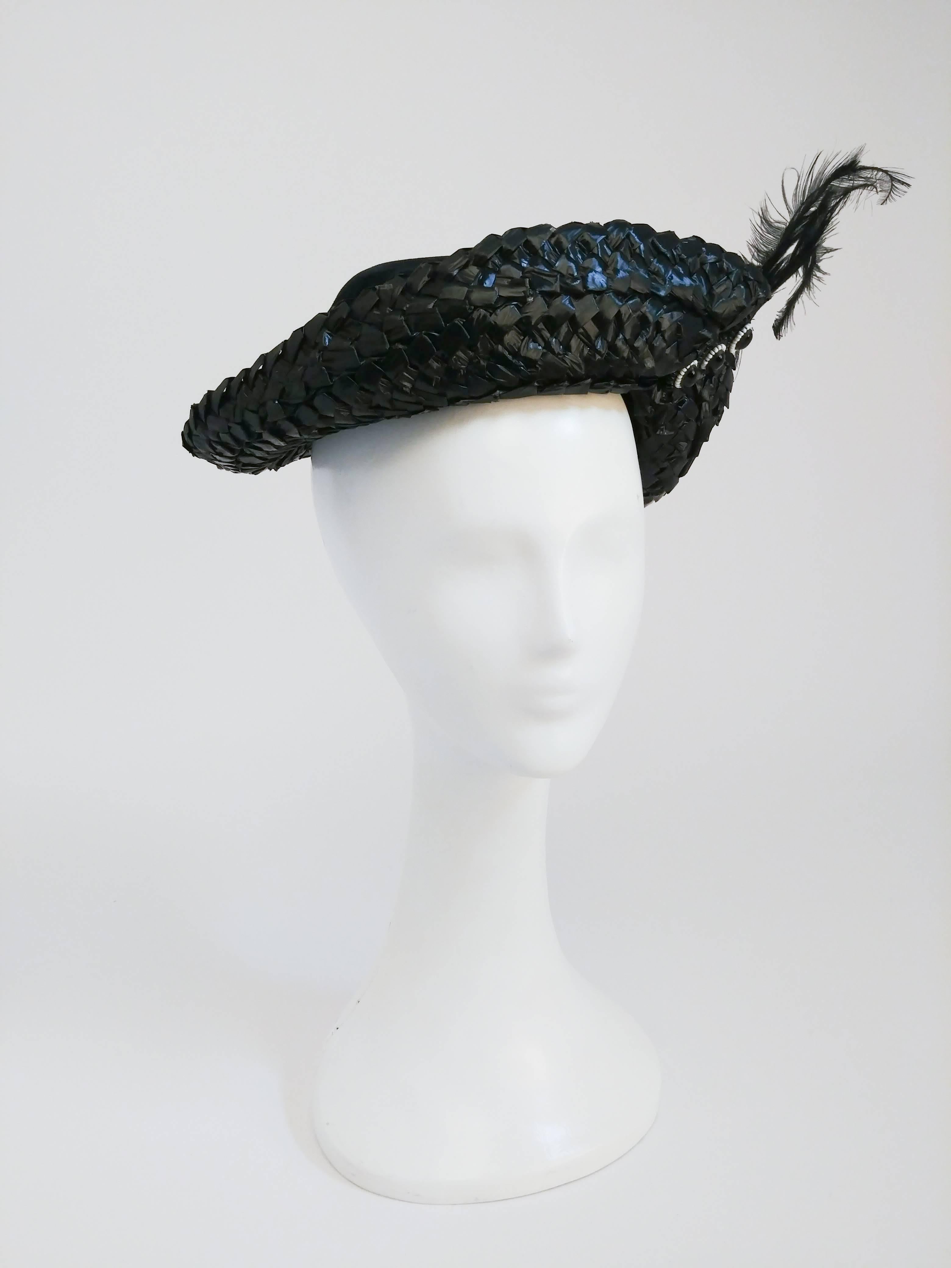 1930's Black Silk Velvet and Raffia Hat. Black silk velvet hat with raffia brim, glass bead and feather embellishments. Elastic band to secure hat to head. 22 inch circumference.