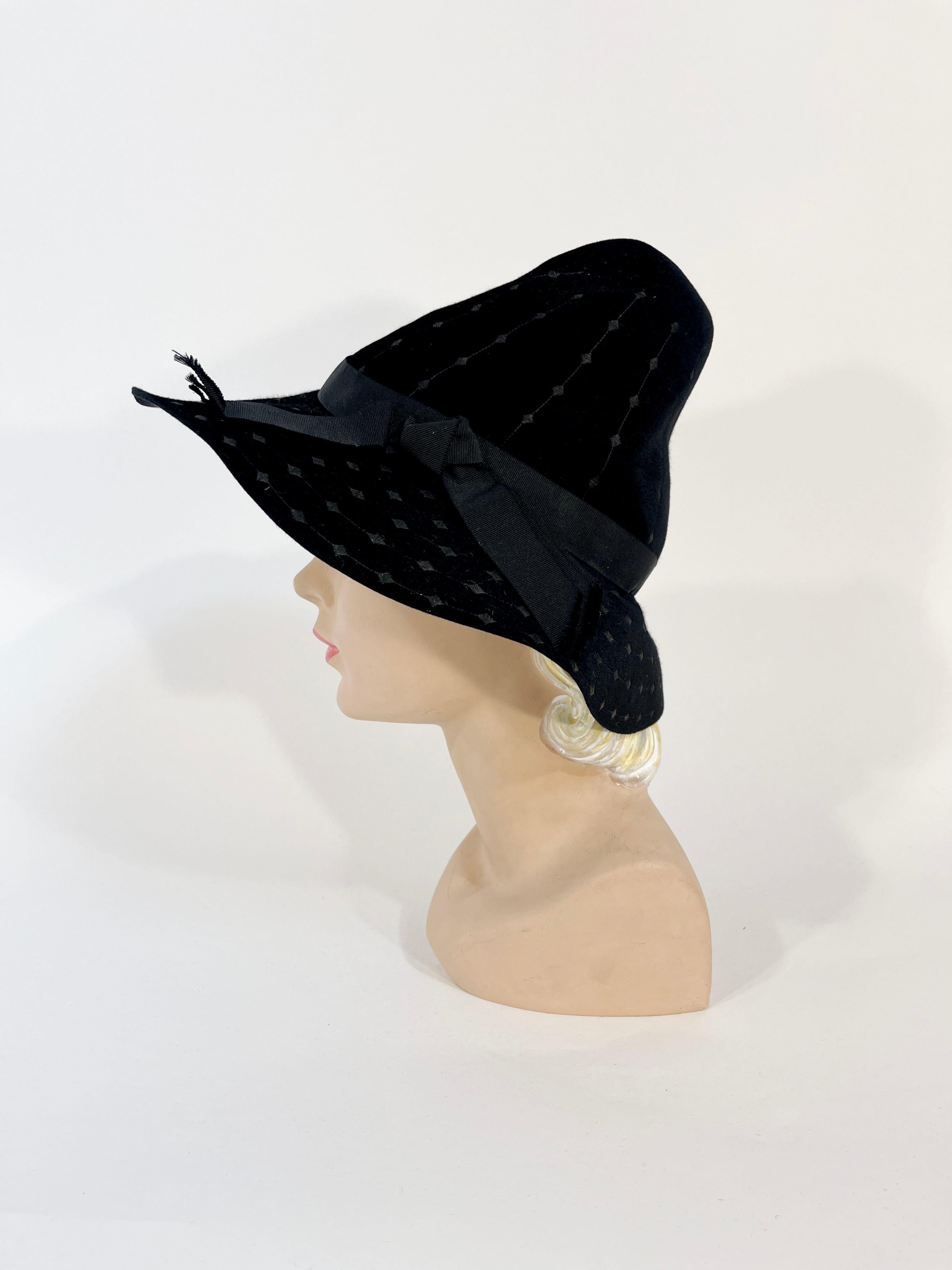 1930s Black woolen felt high fashion fedora hat featuring a very high shaped crown, a black grosgrain grain hat band, and striped/diamond embroidery throughout. The interior is unlined but the inner crown has a grosgrain hat band. This hat is