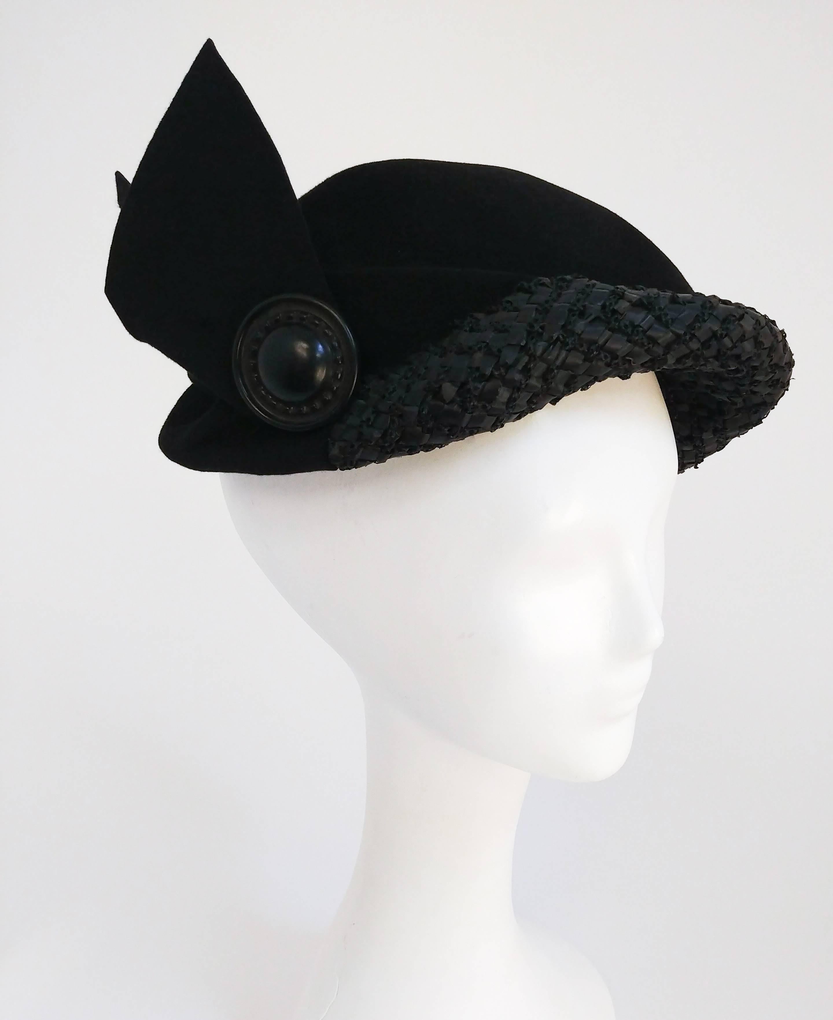 1930s Black Wool Hat w/ Raffia Brim. Large decorative button at side with geometric winged embellishment. 