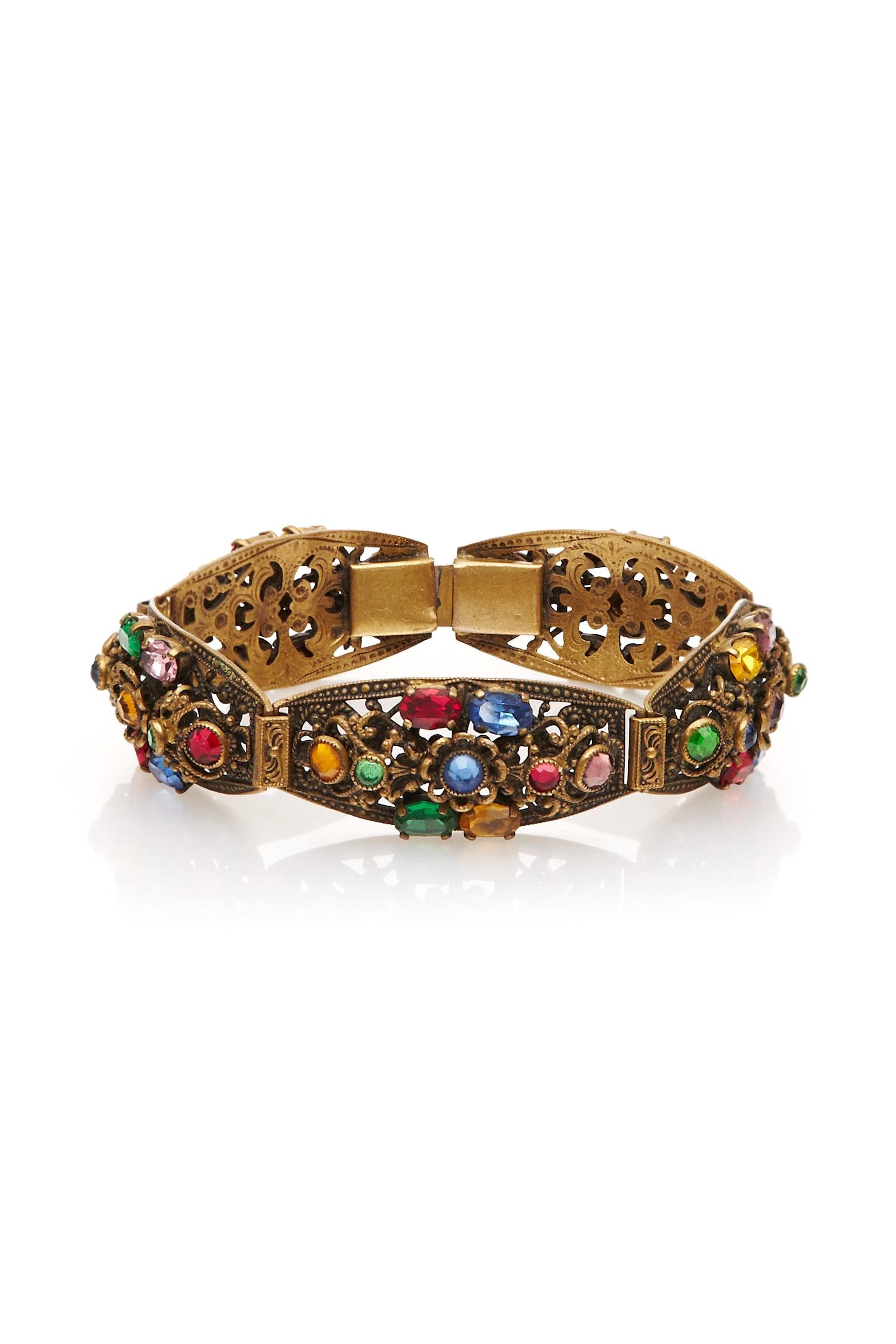 Beautiful 1930s bracelet made up of five articulated gilt metal sections with pretty multcoloured Czech glass decoration.  It fastens with a push clasp fastening and is in excellent condition.

Measurements:
Length: 19cm
Width: 1.7cm/ 0.7”