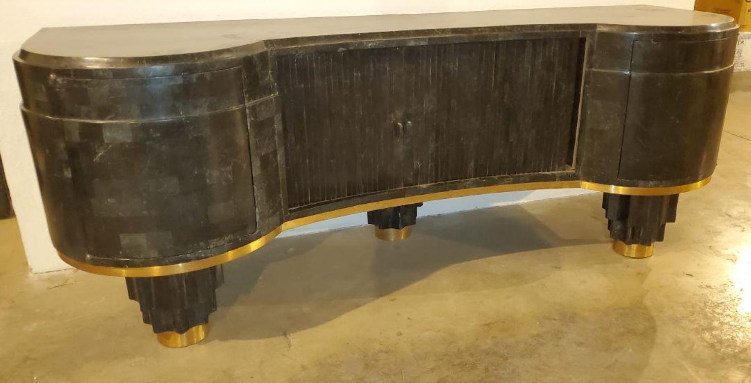 Vintage 1930s tessellated bow front sideboard buffet credenza, middle tambour door cabinet, with side doors, empire skyscraper legs brass bands, all tessellated in black dark green almost black stone.

Beautiful tessellated stone sideboard with