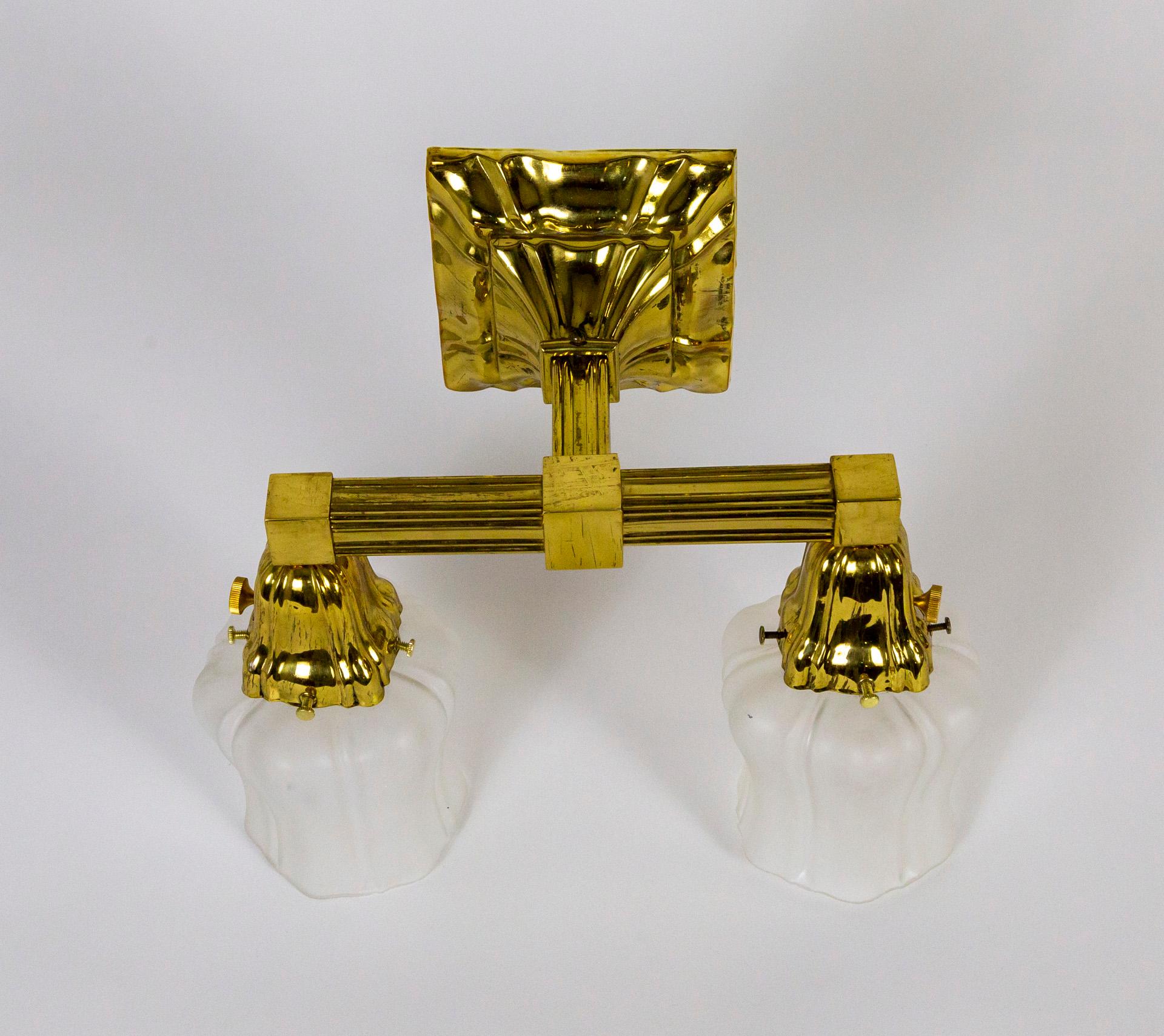 A brass, 2-arm, Sheffield style sconce from the 1930s. With frosted glass shades in a tapered, bellflower shape. With independent switches on the sockets. Newly wired. 12.75
