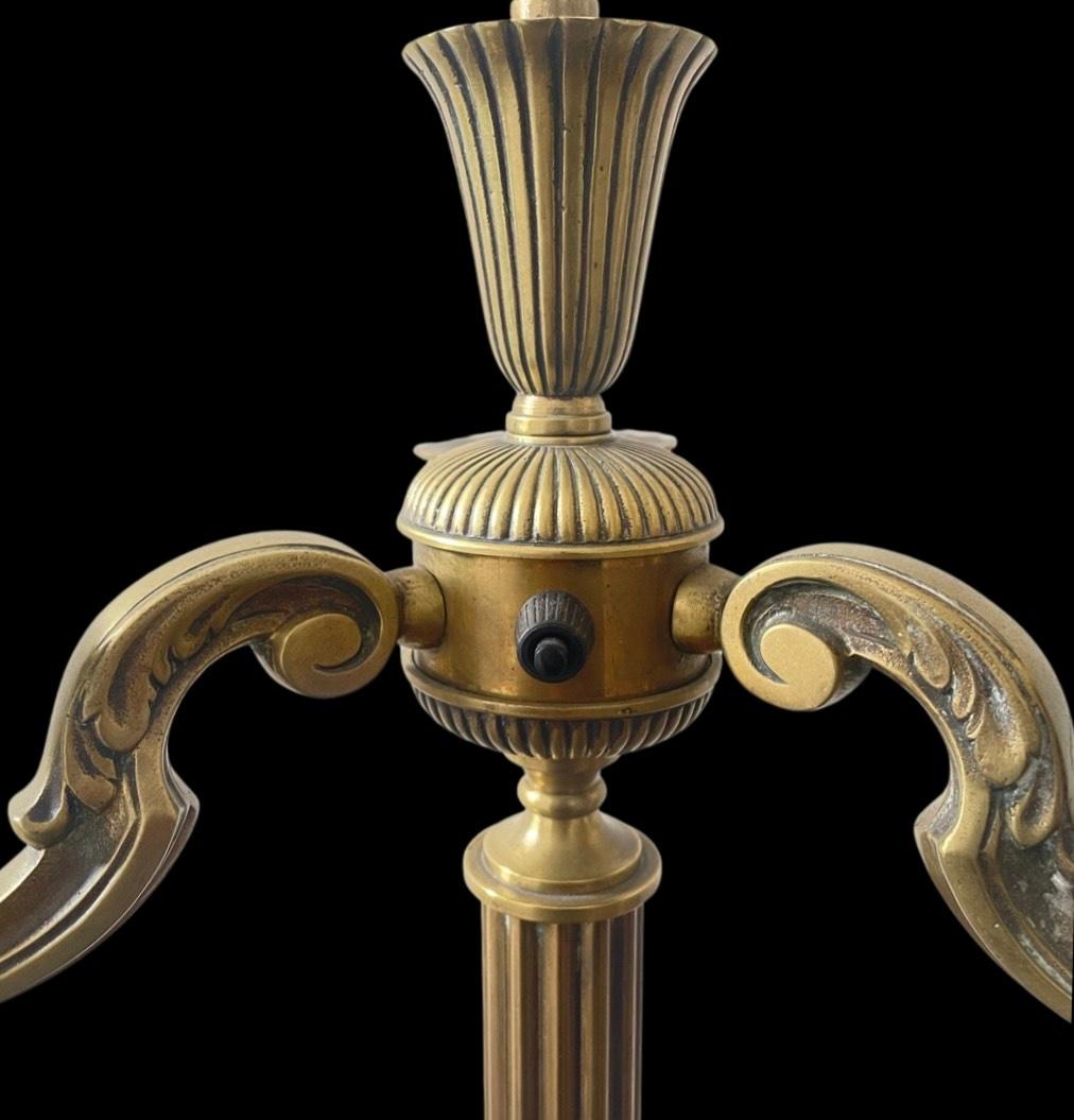 The timeless elegance of our exquisite 1930's Brass Candelabra Regency Floor Lamp, this magnificent piece effortlessly transports you to the opulence of a bygone era with its regal charm and sophisticated design. Crafted from premium brass, this