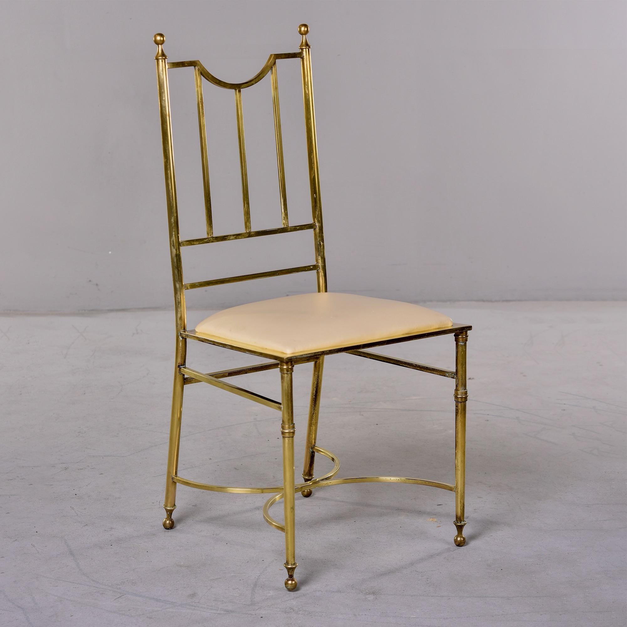 Circa 1930s side chair with elegant solid brass frame with spindle back, curved X-form stretcher, and ball-capped feet. Seat has new bone colored leather upholstery. Found in the US. Unknown maker. 

Measures: Seat Height: 19” Seat Depth: 16” Seat