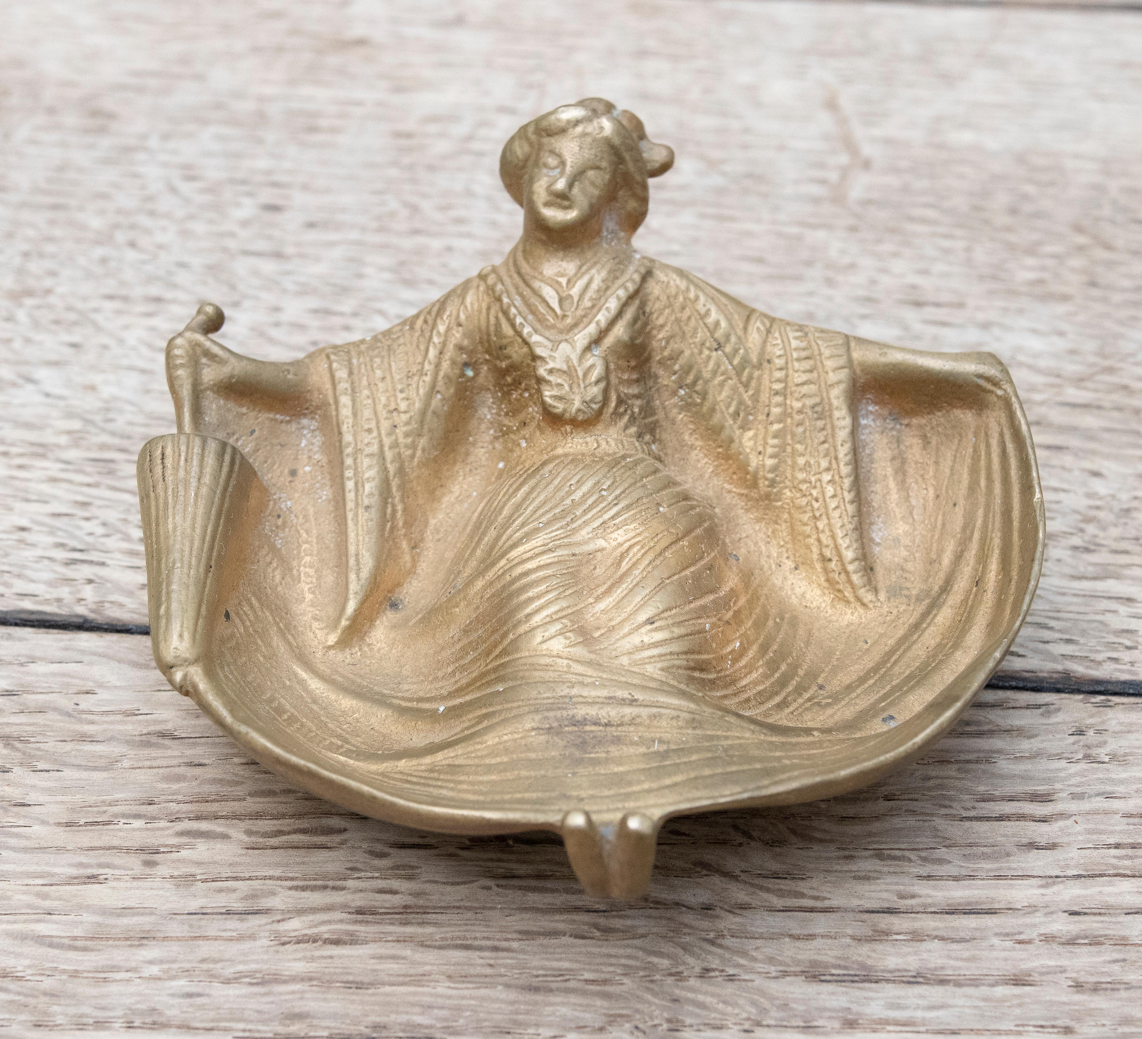 1930s Bronze ashtray of a woman dressed in front and nude at the back.