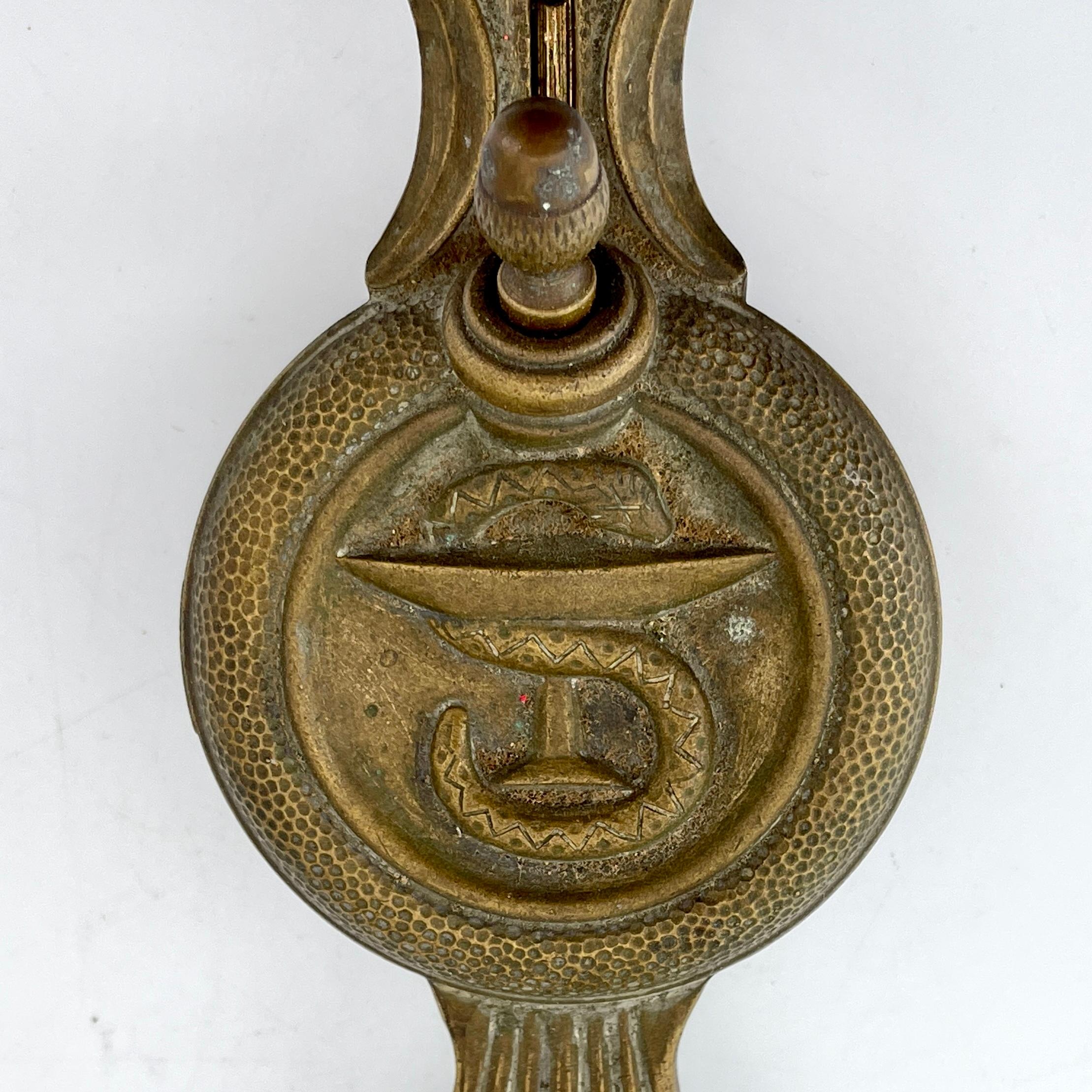 Heavy bronze striker/lighter with snake on martini glass or hygieia symbol for health.
Marked; Siegfried DDD (30) McMXXXVII (1937)
No flint included, so not making fire, sold as-is, as a prop.

Measures: L 6.25 x W 2.75 x H 1.75 in.
1.05 lbs.