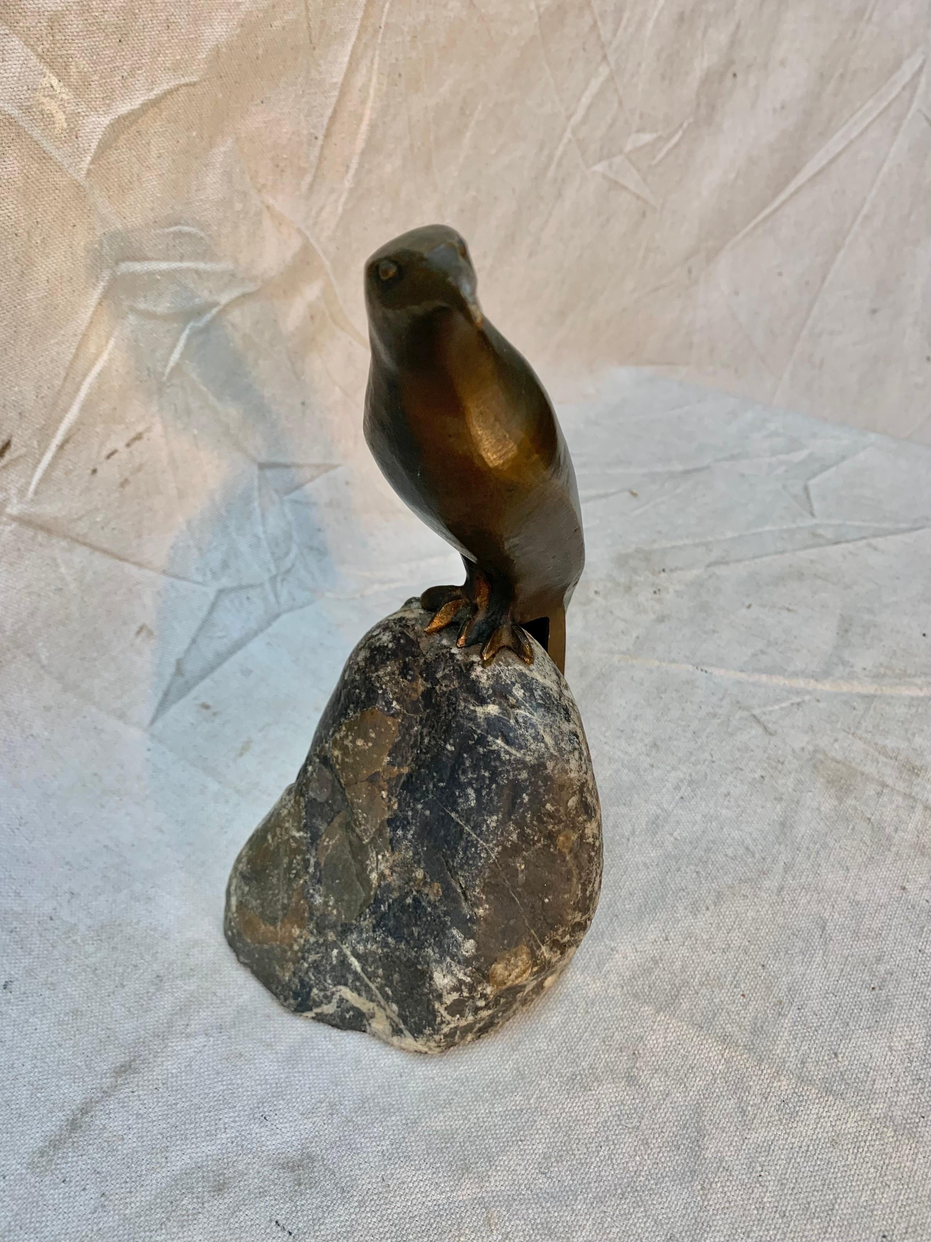 This sculpted antique bronze Art Deco style falcon is seated on natural granite by French artist Charles Reussner (1886 - 1961). The dark shades of the natural granite contrast beautifully with the rich, warm patina of the bronze. The sculpture is