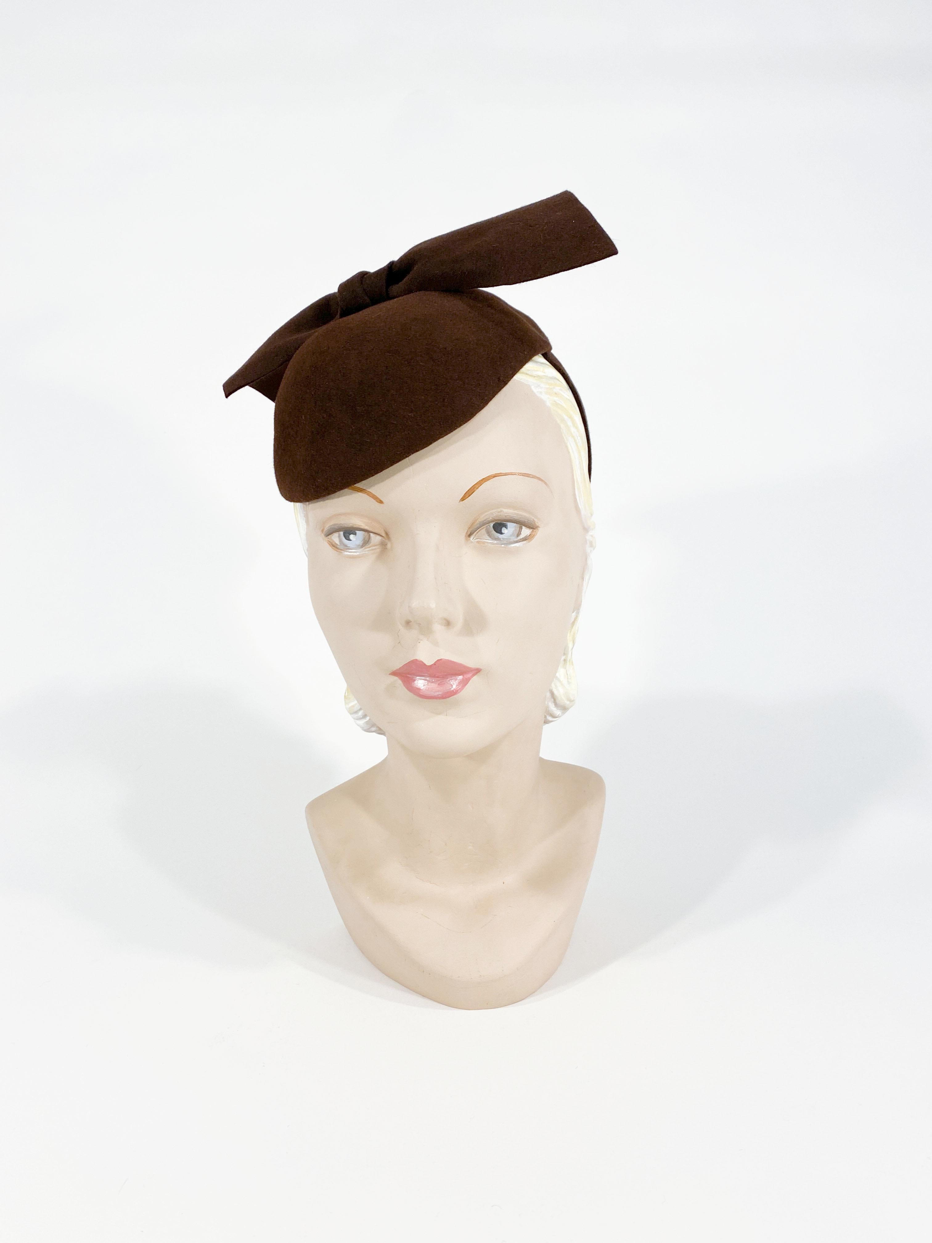 1930s handmade brown sculpted beaver fur felt perch hat with wide security strap decorated with an enlarged felt bow.