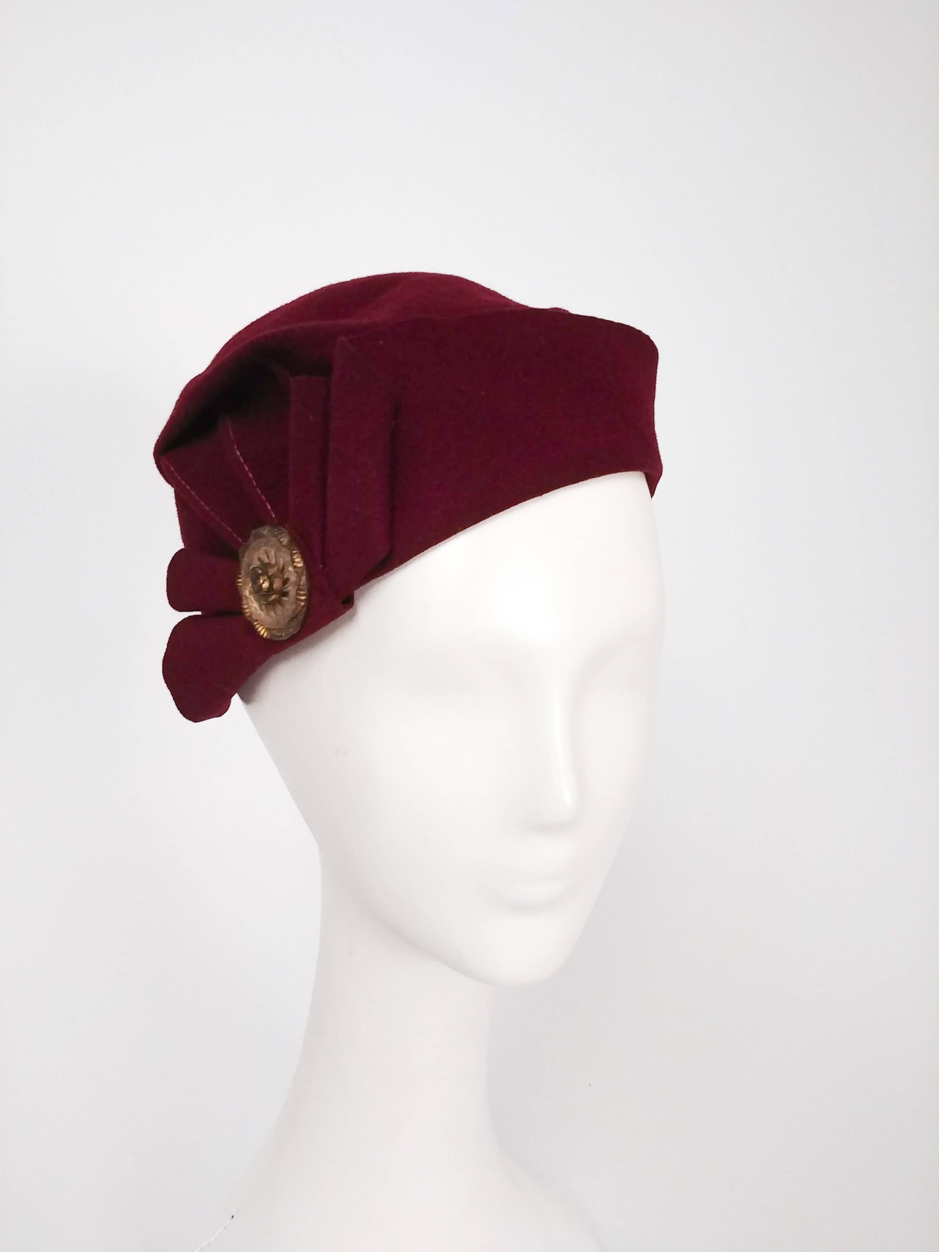 1930s Burgundy Pleated Wool Felt Hat. Decorative bronze brooch at side. 