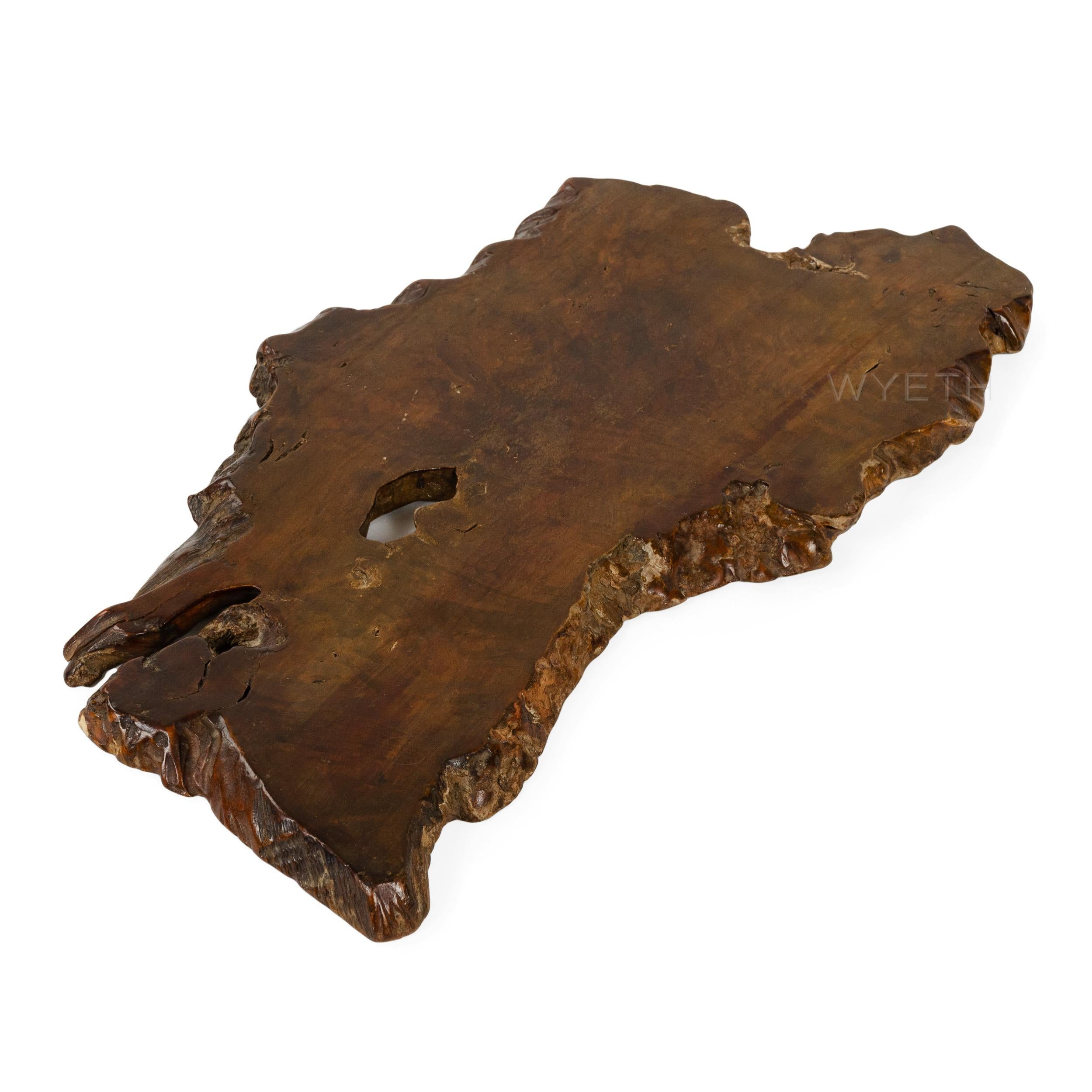 A shapely burl wood tray or platter with live edges all around.