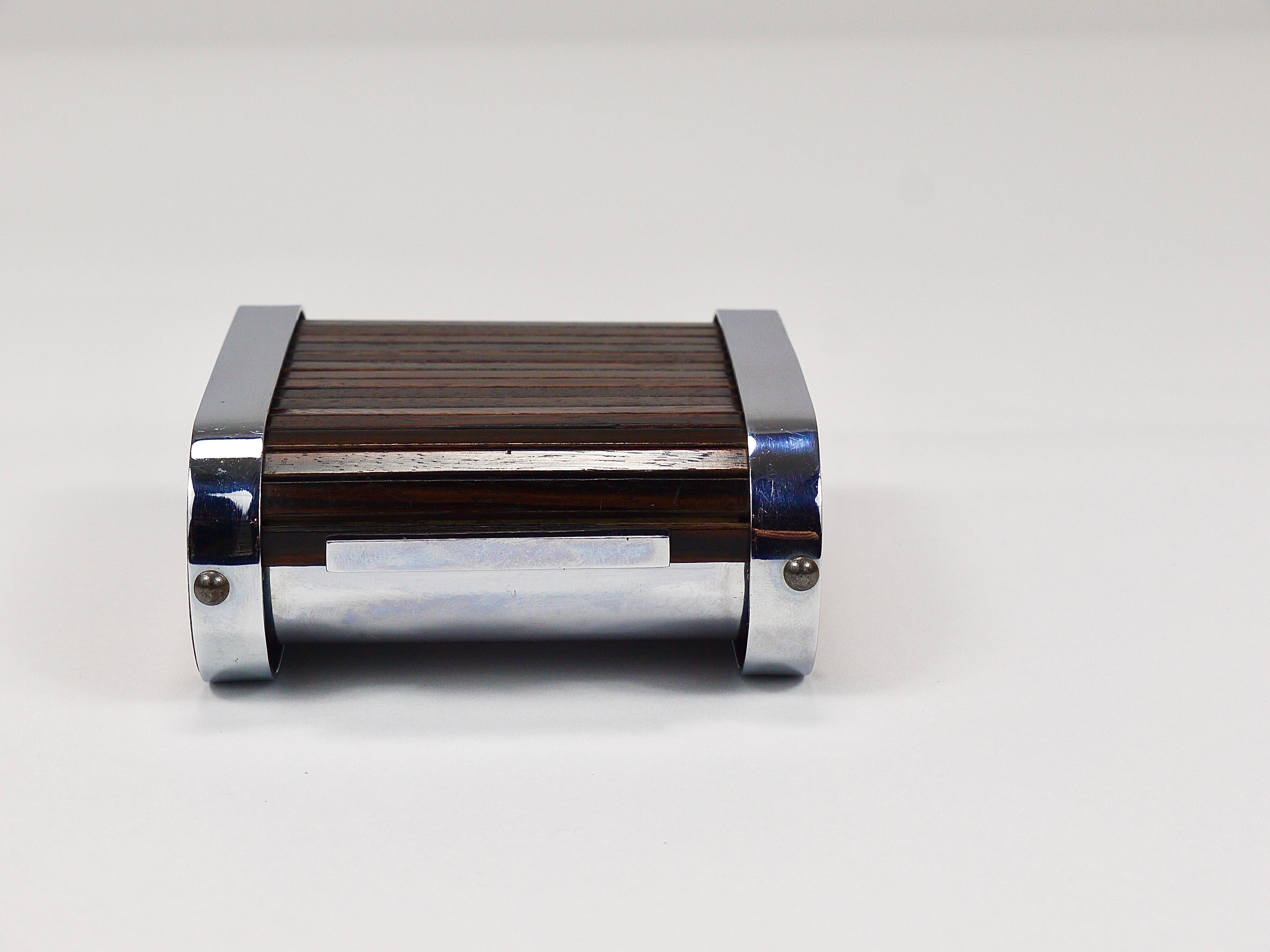 A rare storage box or cigarette dispenser with a roll down lid from the 1930s, this is an early design by Carl Aubock I. Handmade of wood and nickel-plated brass. In good condition.