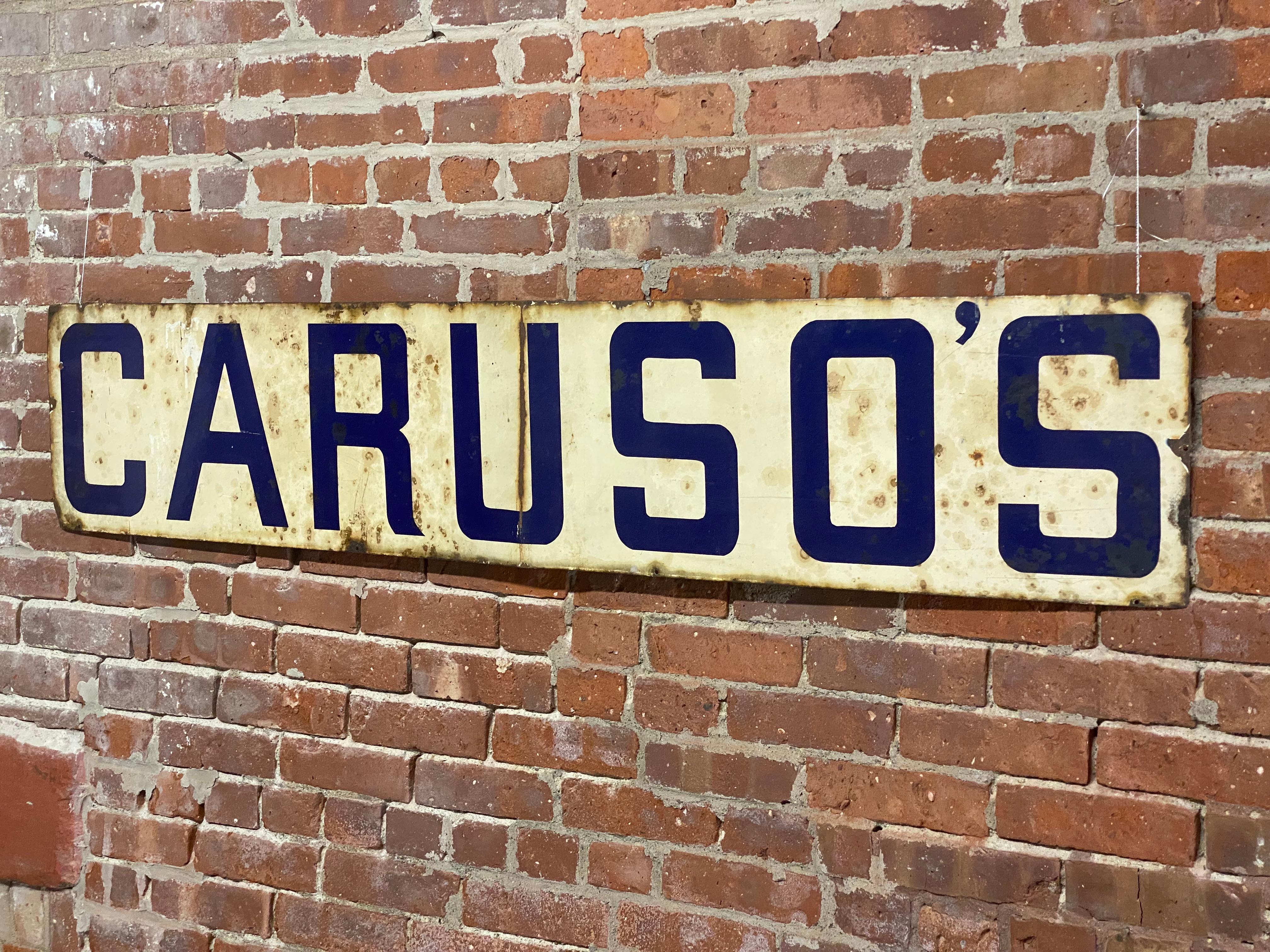 Caruso's cobalt blue and white enamel wall mounted sign. From the restaurant in Poughkeepsie, NY's Little Italy neighborhood. Circa 1930-40. Originally mounted on the side of the building's brick facade. Baked porcelain enamel on metal. Good to fair