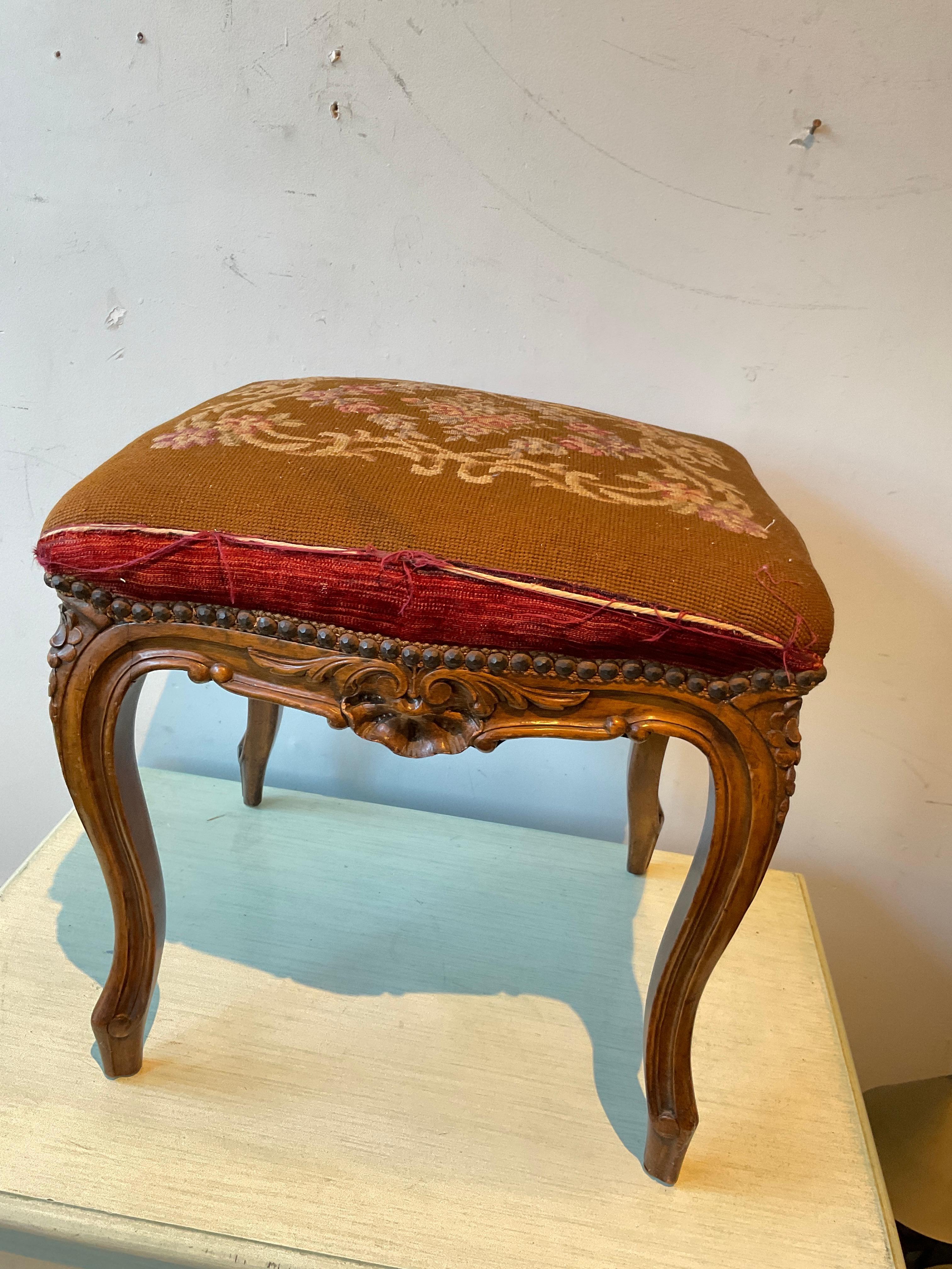 1930s French hand carved wood footstool. 
Needs reupholstering. Some grey paint spots on leg as shown in pictures.