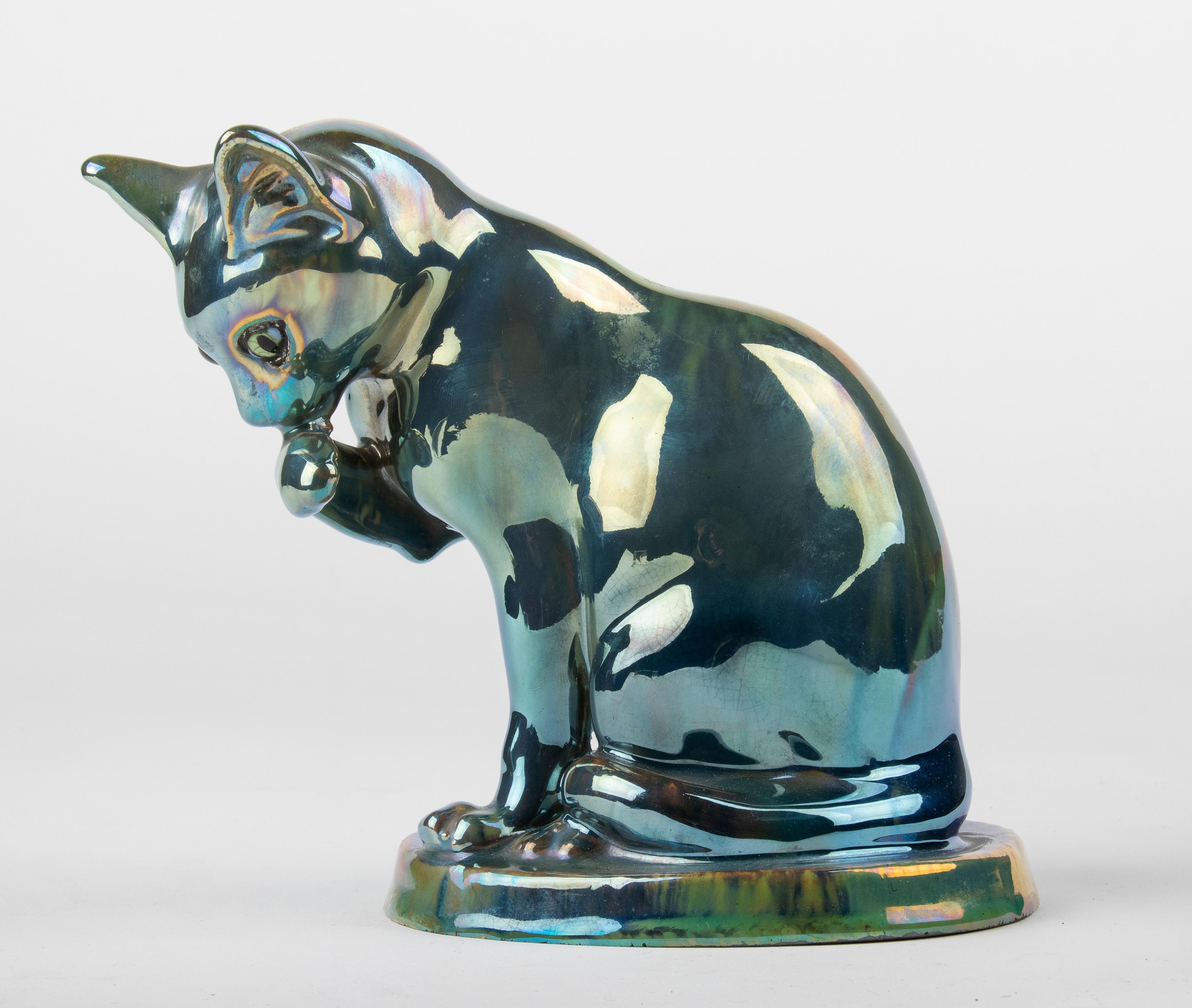 Lovely ceramic figurine of a cat from the Art Deco period. The cat is marked 'Rambervillers', 'Unis France' and 'A. Cytère'. The figurine has a nice blue / green / purple iridescent metal glaze, called Gres flammes.
Designed by the ceramist