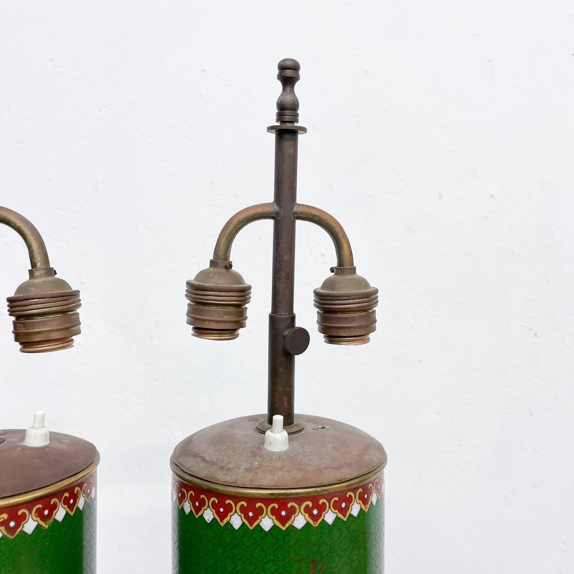 1930s Chinese cloisonné table lamps spirited enamel art in vivid green and blue on a round carved rosewood pedestal base. No design verification visible.
Measures: 29 tall (top of finial) x 5 in diameter inches
Original unrestored vintage
