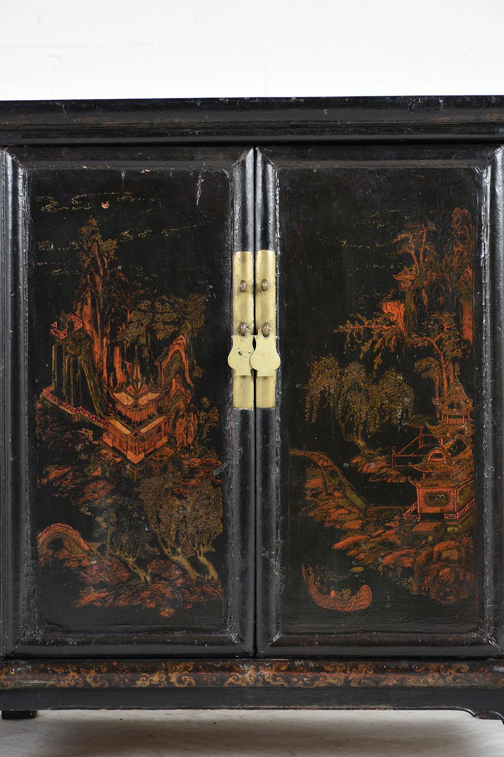 This painted cabinet features a mountainside Chinese Village in striking red and gold colors with a dark wash over them. The cabinet depicts a different part of the village showing homes, trees, bridges, and the mountains. The cabinet is painted red