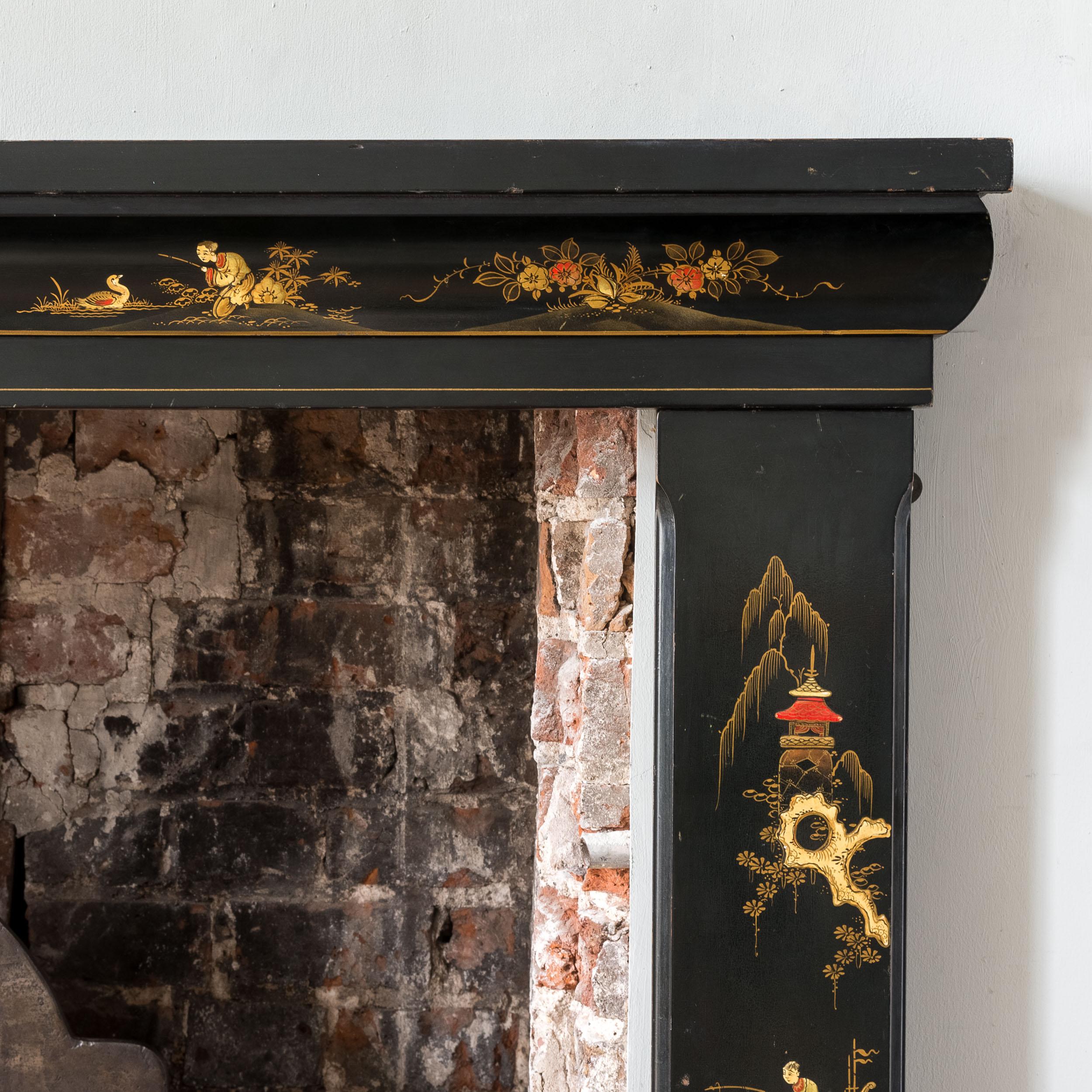 An elegant 1930s Chinoiserie ‘Paifang’ form fire surround, japanned with gilt and painted decoration to the frieze and jambs.

