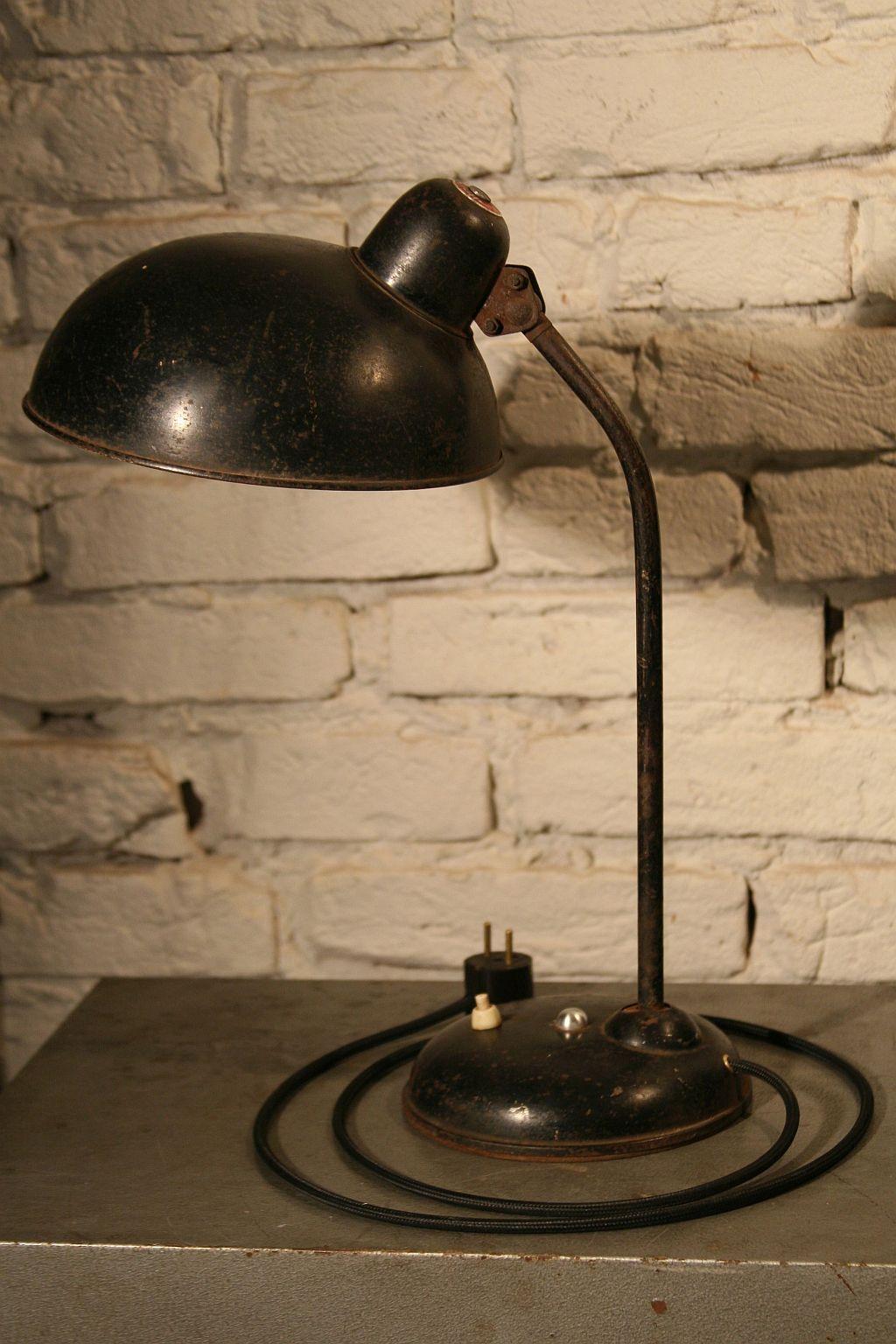 An original desk lamp from the 1930s designed by Christian Dell, produced in Breslau by the German company Helo with the trademark of the Kaiser Leuchten KG Company.
Construction:
The lamp is made of steel, the lower and upper part of the arm has