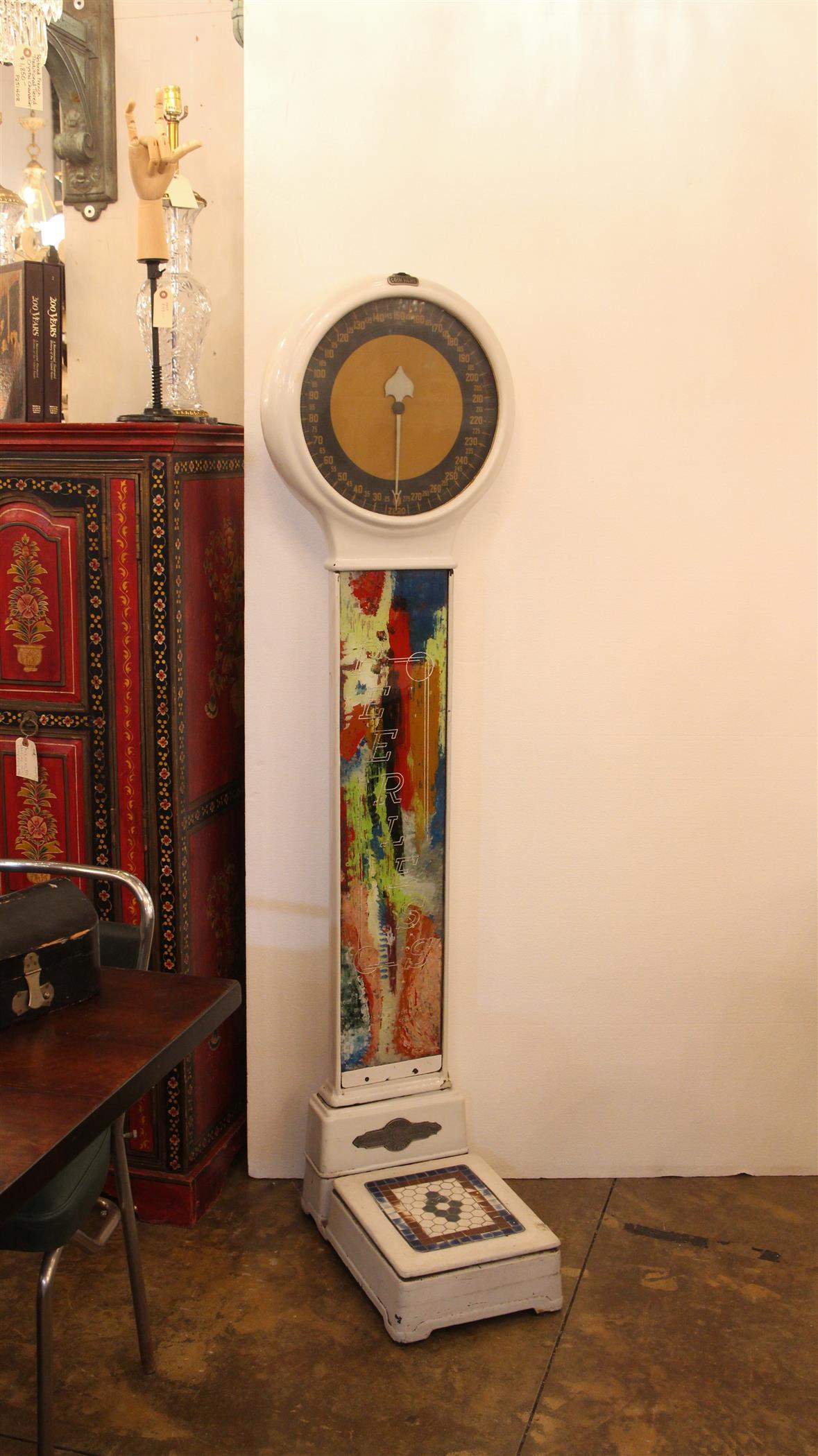 1930s cast iron Peerless lollipop scale with a colorful glass front and base and white enamel. The front is glass covered and splashed with red, blue, orange, green and white abstract colors with Peerless stamped in silver. Our understanding is the
